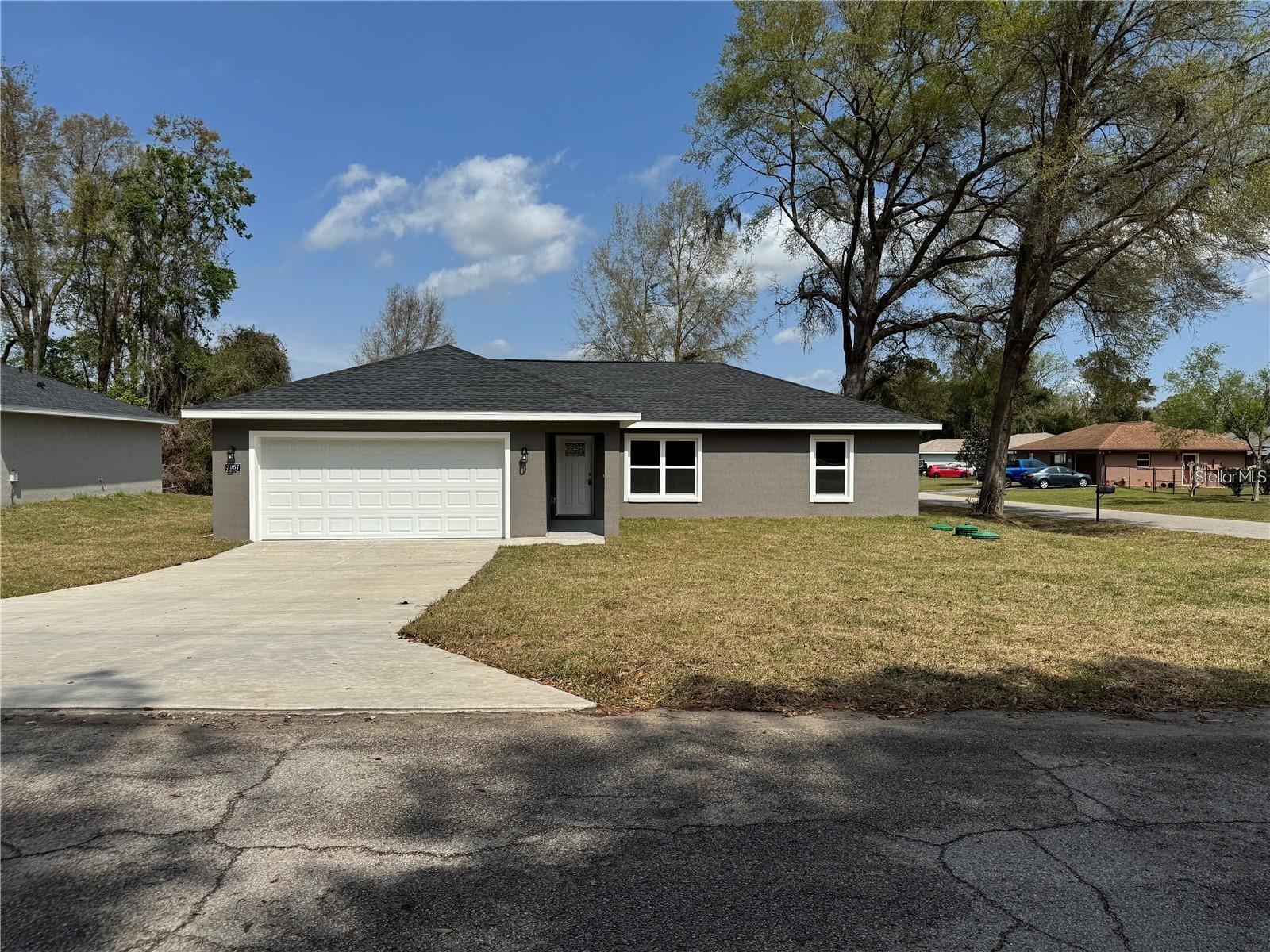 Brand-New Construction Home on a Desirable Corner Lot! Featuring a sought-after split floor plan and 2-car garage, this home offers an open-concept design with high ceilings, luxury vinyl plank flooring, upgraded lighting, and modern ceiling fans throughout. The corner lot provides added privacy, extra yard space, and enhanced curb appeal. The kitchen is equipped with stainless steel appliances, stone countertops, and upgraded cabinetry, all overlooking the spacious living and dining areas. The primary suite features a tray ceiling, walk-in closet, and a private ensuite bath with double vanities and a tiled walk-in shower. Guest bedrooms have generous closet space and abundant natural light. The guest bathroom includes stone countertops and a tiled tub surround. Enjoy the covered front entry, as well as sliding glass doors leading to the patio and backyard—perfect for relaxing or entertaining.Don't miss this beautiful new home—schedule your private showing today!