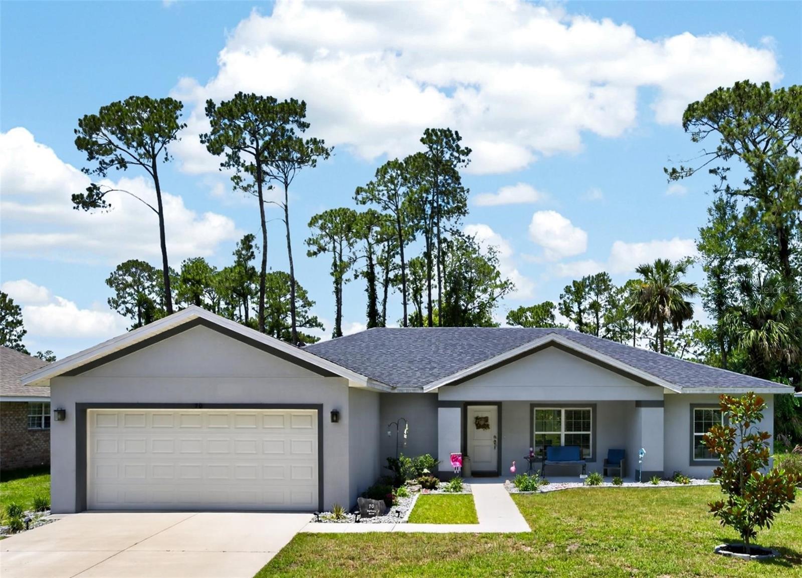 Welcome to 70 Parkway Drive, a beautifully maintained 2023-built concrete block residence that blends modern comfort with effortless Florida living. Offering approximately 1,721 square feet of living space, this 3-bedroom, 2-bath home features a thoughtfully designed floor plan that maximizes comfort, functionality, and everyday living. From the moment you step inside, you'll appreciate the warm and inviting atmosphere enhanced by luxury vinyl plank flooring throughout, creating a seamless, carpet-free design that is both stylish and easy to maintain. The open-concept living and dining areas flow effortlessly into the well-appointed kitchen, making entertaining and daily living a breeze. The kitchen showcases upgraded cabinetry, solid quartz countertops, and a stainless steel appliance package, combining modern style with everyday practicality. The spacious primary suite offers a relaxing retreat with a well-appointed bath featuring a tiled walk-in shower and contemporary finishes. Two additional bedrooms provide flexibility for family, guests, or a home office, while the functional layout accommodates a variety of lifestyles. Step outside to the expansive covered lanai, an ideal extension of the living space and the perfect setting for morning coffee, outdoor dining, weekend barbecues, or relaxing evenings overlooking the spacious backyard. Situated on an oversized lot with plenty of room for recreation, gardening, pets, or even a future pool, the outdoor space offers endless possibilities. A 2-car garage provides added convenience and storage. Move-in ready and built with today's lifestyle in mind, this exceptional home offers the perfect blend of modern finishes, durable concrete block construction, quality craftsmanship, and comfortable living. Conveniently located near shopping, dining, schools, parks, and major roadways, 70 Parkway Drive is ready to welcome you home.