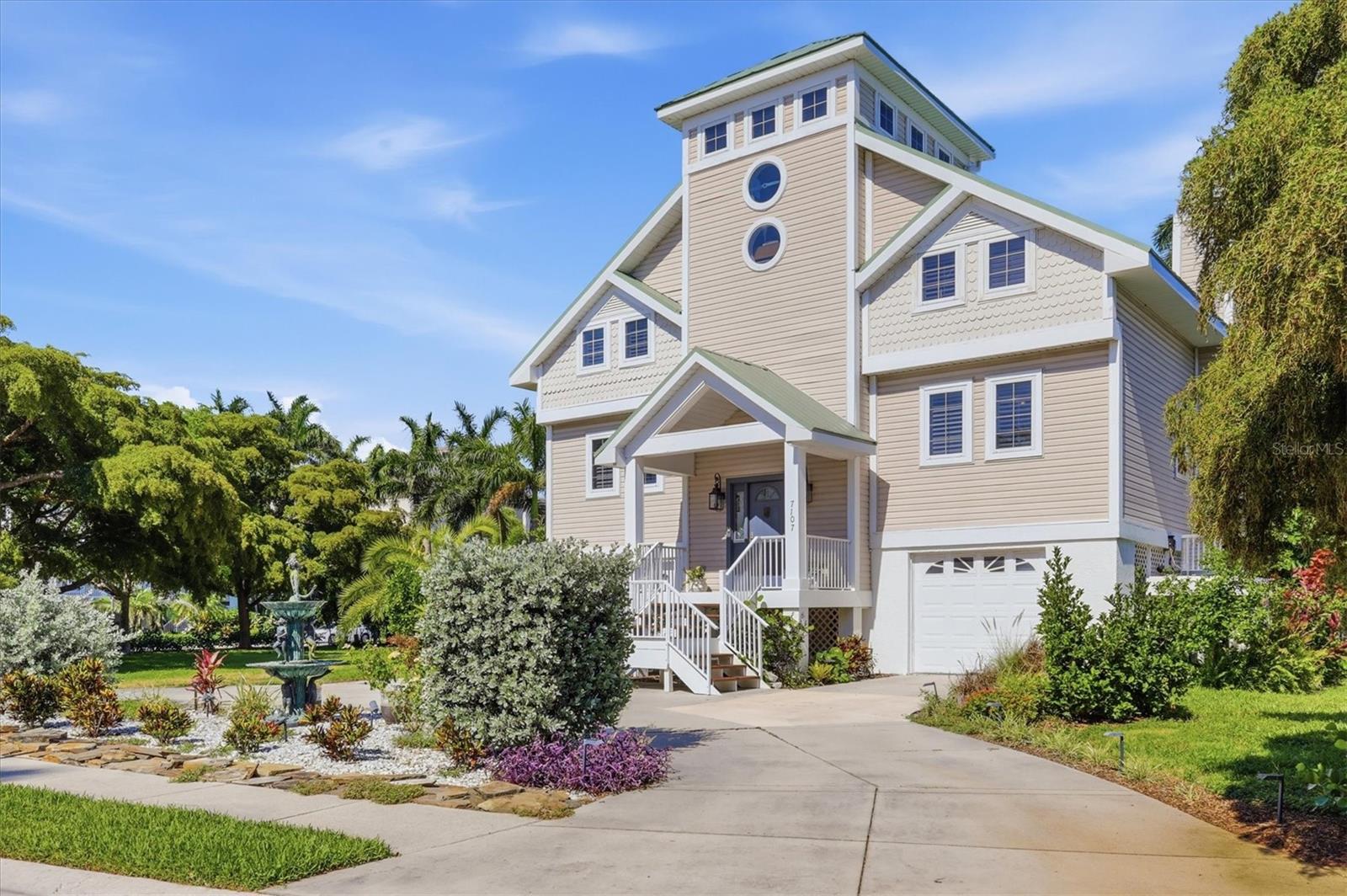 Discover the opportunity to own a distinctive residence in the gated waterfront community of Hawks Harbor, ideally between Sarasota and West Bradenton with convenient access to gorgeous Gulf beaches, IMG Academy, Sarasota-Bradenton International Airport, dining, shopping and cultural attractions. On an oversized 0.37-acre homesite with mature landscaping and privacy potential, this three-story home includes a deeded 26-foot boat slip in the Hawks Harbor marina with direct access to Sarasota Bay and no bridges to open water. Offering approximately 2,070 square feet of interior living space and 3,829 total square feet, the residence features three bedrooms and three full baths, with room for customization and expansion. Natural light fills the open-concept living area featuring volume ceilings, French doors to the wraparound terrace, hickory hardwood flooring and a renovated wood-burning fireplace. The kitchen includes granite countertops, a spacious center island, newer stainless steel appliances, a custom backsplash and a new sink. The recently renovated baths showcase Moroccan brass and intricate tile detailing and feature custom lighting (shower glass to be installed in primary bathroom, not pictured). The primary suite features two closets and an expansive loft-style flex space overlooking the living area, ideal for a dressing area, office or additional storage, while the second bedroom also includes a generous walk-in closet. Additional improvements include a 2023 metal roof, renovated deck, fresh interior paint, double-pane windows, irrigation system, central vacuum setup and two separate newer air-conditioning systems (2023 and 2021). The top level features a windowed cupola with an outdoor rooftop viewing deck ideal to survey the landscape of Hawks Harbor with a peekaboo view of the Bay. A designated space beneath the home offers potential for a future elevator installation. The oversized homesite allows room to expand the residence by 1,000+ square feet, add an outdoor pool and entertainment space, or construct an additional garage bay, subject to approvals. According to the seller, the property did not experience flooding during the 2024 storms. Additional features include a two-car under-building garage with storage space and generator pad. This residence represents one of the compelling entry points into Hawks Harbor, offering exceptional opportunity to personalize, expand and build long-term value with boating access in one of the Sarasota-Bradenton area’s ideally positioned gated waterfront communities.