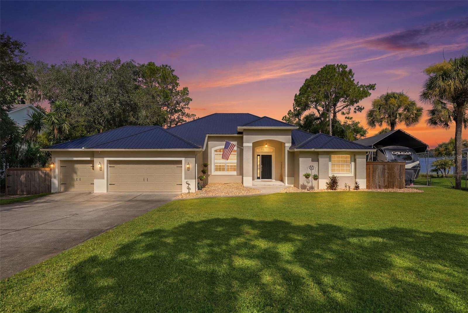 Experience the best of Florida lakefront living in this beautiful custom-built home on Lake Emma in Groveland. Built in 2006, this thoughtfully designed 3-bedroom, 2-bath home offers 1,948 square feet of comfortable living space with breathtaking water views and extensive recent upgrades.

The open floor plan is filled with natural light, creating a seamless connection between the spacious living areas and the picturesque lake beyond. The completely remodeled kitchen (2024) features new cabinetry, an LG appliance package, 62 square feet of granite countertops, an oversized sink, new faucet, and garbage disposal, making it the perfect space for everyday living and entertaining. Additional 2024 improvements include a new deck with railing, covered RV pad with 30-amp service, and new interior ceiling fans.

In 2025, this home received even more impressive updates, including a new 26-gauge metal roof, new 3.5-ton Trane HVAC system, new water heater, new carpet throughout, complete interior paint including the ceilings, new door hardware, hinges and handles, new electrical receptacles and cover plates, new garage door openers, and new lanai ceiling fans. The private dock was also re-decked with treated wood, providing the perfect place to fish, kayak, boat, or simply relax while taking in the peaceful lake views.

Located just minutes from shopping, dining, schools, parks, and major highways, this move-in-ready waterfront home offers the perfect blend of modern updates and tranquil Florida living. Don't miss this rare opportunity to own a beautifully updated home on Lake Emma—schedule your private showing today!