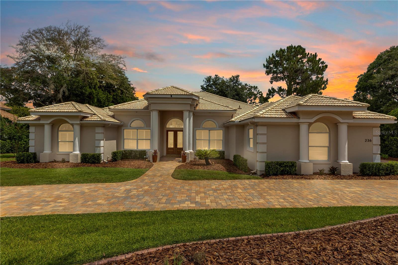 Welcome to an extraordinary opportunity to own a luxury estate in the HIGHLY DESIRABLE gated community of The Estates, located in the DeBary Golf and Country Club, where homes RARELY become available! Nestled on a private 1.06-acre LAKEFRONT lot, this exceptional 4-bedroom PLUS office, 3.5-bathroom residence seamlessly blends timeless elegance, modern efficiency, and resort-style living in one of the area's most exclusive neighborhoods. More than just a home, this is a lifestyle, offering breathtaking views of the lake, community clubhouse, and golf course in a golf cart-friendly neighborhood where you can ride to dinner, enjoy a round of golf, play pickleball, and enjoy everything this premier community has to offer. From the moment you arrive, the home's IMPECCABLE curb appeal is evident with professional landscaping, a spacious 3-car garage, and a beautifully maintained exterior. Inside, you'll find NEW stunning bamboo flooring, extensive crown molding, plantation shutters, and BRAND-NEW carpeting. Two tubular skylights further enhance the bright and airy atmosphere, bringing in natural light throughout the day. The expansive floor plan is ideal for everyday living and entertaining. Fully retractable sliding glass doors create a seamless transition between the interior and the outdoor oasis, allowing the spectacular views to become part of everyday living. At the heart of the home, the NEW renovated gourmet kitchen is designed to impress with a gas cooktop, gorgeous natural quartzite countertops, under-cabinet lighting, built-in pantry shelving, a mirrored backsplash, and abundant cabinetry overlooking the main living areas and pool. The luxurious primary suite serves as a private retreat featuring a tray ceiling, a spacious walk-in closet with built-ins, dual vanities, and a spa-inspired bathroom complete with a floating soaking tub. Step outside and experience your own private resort. The screened pool area is perfectly designed for entertaining with a fully equipped summer kitchen featuring a range and sink, an additional paver patio with a firepit, a dedicated pool bath, and an outdoor shower with hot and cold water. The pool area has been freshly repainted, the pavers recently resealed, and the new pool cage and screens enhance the outdoor living experience. The backdrop of the lake, clubhouse, and golf course is truly unmatched. This home is as practical as it is luxurious, offering PAID-OFF solar panels that service both the home and pool, two gas tankless water heaters, a gas pool heater, a well for the irrigation system servicing the professionally landscaped grounds, and numerous smart home features. Both 100" TV's included! (in Family & Living room). The oversized 3-car garage includes cabinetry, overhead storage, and an additional utility sink, adding exceptional functionality. Even the property's mature peach tree adds a unique touch to this remarkable estate! Homes in The Estates are seldom offered for sale, making this an exceptional opportunity to own a meticulously maintained estate that combines privacy, sophistication, energy efficiency, and an unparalleled lifestyle. With over an acre of land, spectacular lakefront views, and the ability to hop on your golf cart to enjoy the clubhouse, golf course, pickleball courts, basketball courts, and community amenities, this is more than a home—it's the lifestyle you've been waiting for! This home may be under audio or visual surveillance.