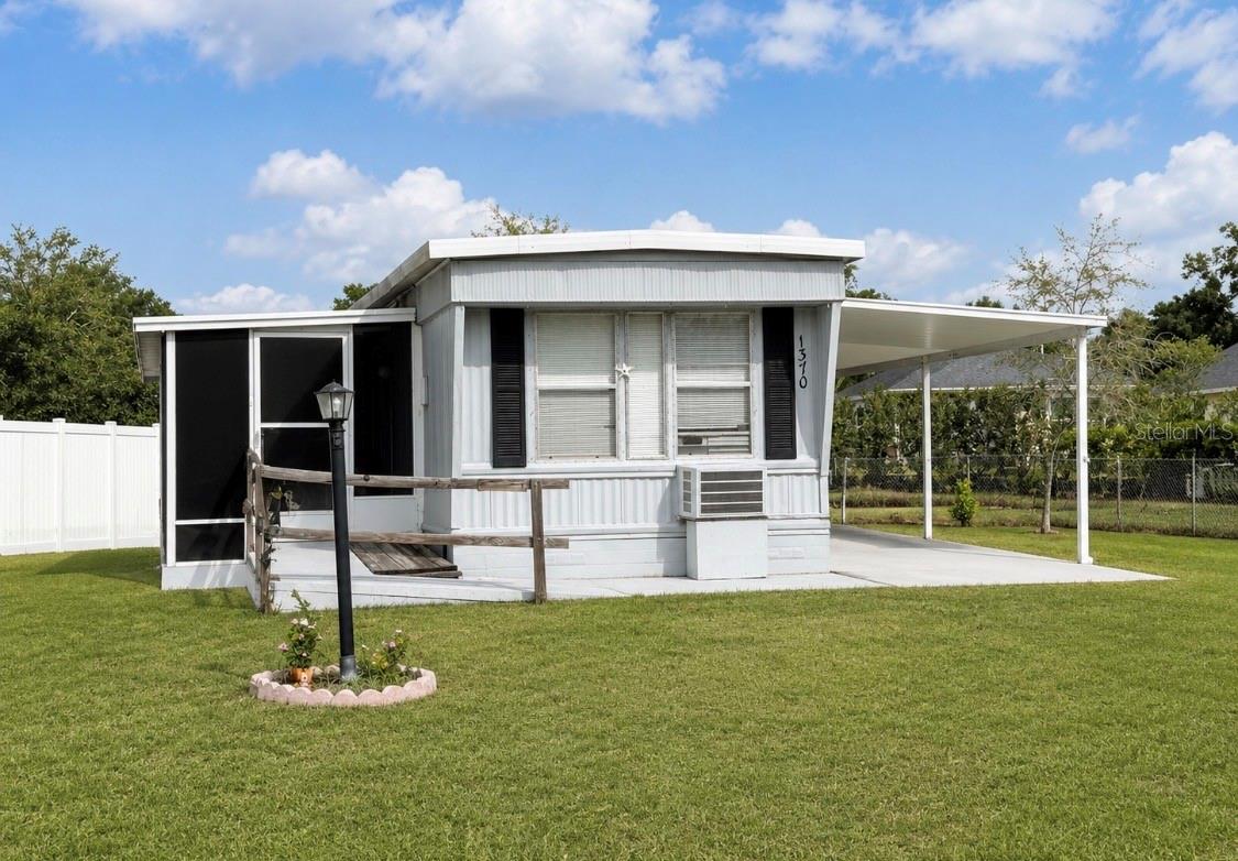 YOU OWN THE LAND!! Better Yet... NO HOA!! Even Better.... NO AGE RESTRICTIONS!! BRING THE BOAT  OR THE RV! This 2-bedroom, 1-bath mobile home features a nice-sized lot with a Florida room, as well as a spacious 43 ft long carport. There is vinyl flooring installed in the main living areas. Also included is a storage shed.  Golf cart community! Drive the golf cart to historic and vibrant downtown Tavares! Seller financing available as well!! (with acceptable terms)