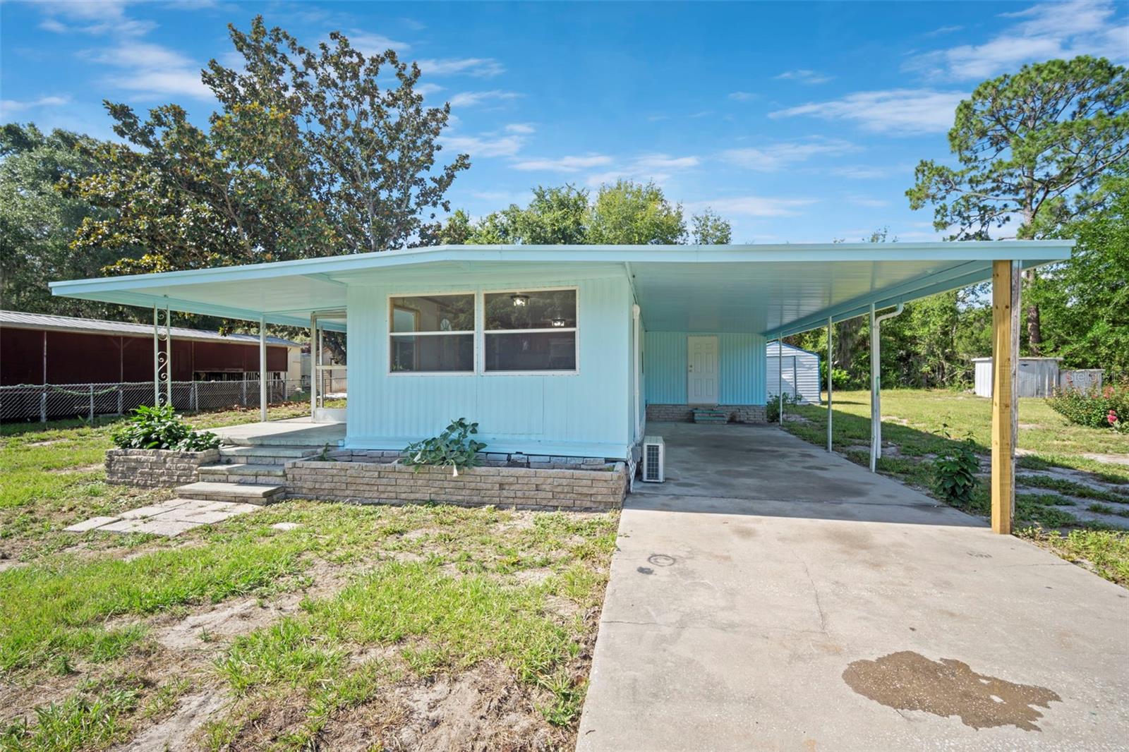 Recently revamped, this 3-bedroom, 1-bath mobile home sits on approximately half an acre in Lake Panasoffkee, offering affordable ownership and room to enjoy the outdoors. Interior features include laminate flooring, wood cabinets, and mini-split A/C, while the exterior offers a covered front porch, carport, and storage. Outside, you'll find plenty of space for pets, parking, outdoor hobbies, or simply enjoying the laid-back lifestyle that makes Lake Panasoffkee so popular. With no HOA, you'll appreciate the freedom and flexibility this property provides. Enjoy easy access to fishing, boating, and outdoor recreation opportunities. Nearby attractions include Lake Panasoffkee Fisherman's Lodge, Marsh Bend Outlet Park, local parks, and favorite dining spots such as Catfish Johnny's and Big Bass Grill. Whether you're looking for a primary residence, seasonal retreat, or investment opportunity, this property offers affordable ownership with room to make it your own. Cash only. Property is being sold As-Is.