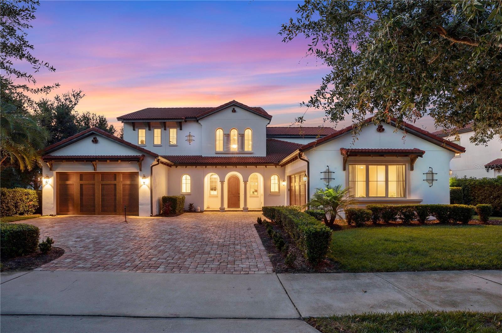 Welcome to 15591 Panther Lake Drive, a stunning 5-bedroom, 3.5-bath Mediterranean-inspired waterfront residence in the highly sought-after Lakeshore Preserve community of Winter Garden. Showcasing exceptional craftsmanship and timeless architectural elegance, this home offers the perfect blend of luxury, comfort, and Florida lifestyle living.

Outstanding curb appeal features a bright stucco exterior, terracotta tile roof, rich wood garage doors, decorative arches, tropical landscaping, and a paver driveway. Additional highlights include two 2-car garages, dual HVAC systems (2024), and a tankless water heater.

Inside, a grand two-story foyer and dramatic staircase welcome guests with soaring ceilings, elegant finishes, abundant natural light, and beautiful water views. Rich wood-look tile flooring flows throughout the main living areas. The chef-inspired kitchen features custom cabinetry, granite countertops, apron-front sink, under-cabinet lighting, premium stainless steel appliances, gas cooking, an oversized center island, and an expansive walk-in pantry with floor-to-ceiling shelving. A convenient mudroom connects to the laundry room.

The spacious family room showcases a tray ceiling with stained wood accents, a gas fireplace, and large sliding glass doors that seamlessly connect indoor and outdoor living spaces. The first-floor primary suite offers tray ceilings, large walk-in closets, and a spa-inspired bath. A dedicated first-floor office provides an ideal work-from-home space.

Upstairs, the expansive loft and oversized bonus room offer endless flexibility for a media room, game room, fitness area, home theater, or additional living space. Secondary bedrooms are generously sized, including a private guest suite with an ensuite bath featuring a granite vanity and tiled walk-in shower.

Enjoy Florida living from the oversized screened lanai overlooking tranquil water views and green space. Brick pavers, multiple ceiling fans, and generous covered seating areas create the perfect outdoor retreat. The backyard offers ample room for a future custom pool, spa, and summer kitchen.

Lakeshore Preserve residents enjoy resort-style amenities including a waterfront community pool, sun shelf, cabanas, walking trails, weekly lawn maintenance, and access to Lake Panther via a community launch for canoes, kayaks, and other non-motorized watercraft.

Conveniently located near SR-429, Walt Disney World, Hamlin Town Center, and historic Downtown Winter Garden, this exceptional home delivers luxury living in one of Central Florida's premier communities.