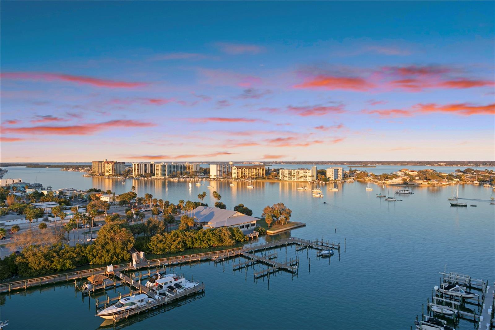 Welcome to Penthouse 1210 at Belle Harbor, a truly exceptional waterfront residence located at 521 Mandalay Avenue in the heart of Clearwater Beach. Offering over 3,426 square feet of interior living space and an additional 575 square feet across four expansive balconies (each bedroom has private balcony access), this 3-bedroom, 3.5-bathroom penthouse delivers an unparalleled blend of scale, sophistication, and sweeping coastal views. 
Designed for both elegance and comfort, the residence features travertine and ceramic tile flooring throughout the main living areas, expansive windows, and a thoughtfully designed layout that flows seamlessly from indoors to out. The four large balconies wrap the entire penthouse, creating multiple vantage points to enjoy sunrise and sunset, lending to one of the most visually stunning vantage points in all of Clearwater Beach. Additionally, this unit features a beautifully updated, custom kitchen with high end appliances, millwork range hood, bar seating, and butler’s pantry. Additional rooms include, formal dining space, family room, living room, indoor laundry room, and breakfast nook with panoramic views. 
This listing is further enhanced by a private 45’ boat slip with 15k lift, and water and electrical, two reserved, side-by-side, covered parking spaces, and a climate-controlled storage unit—a rare and highly coveted combination. This penthouse must be experienced in person to fully appreciate its scale, views, and lifestyle. 
An extraordinary opportunity to own one of Belle Harbor’s finest residences on Clearwater Beach.
Belle Harbor is one of Clearwater Beach’s premier luxury condominium complexes, set on six acres of prime waterfront and offering a full suite of resort-style amenities. Residents enjoy 24/7 manned security, a heated pool and spa, fitness center, clubhouse and lounge, billiards room, assigned under-building parking, and a 65-slip private marina. The location places you just moments from Clearwater Beach’s renowned dining, shopping, and year-round activities.