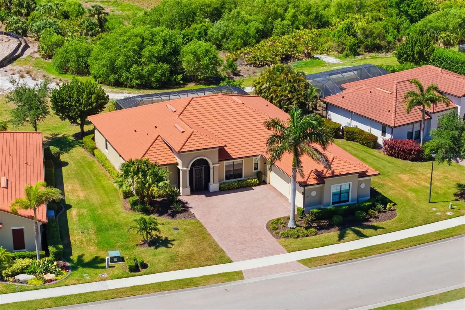 One or more photo(s) has been virtually staged. Major price improvement — exceptional value in a WCI-built Turnberry estate in the highly sought-after Sarasota National. Original owner offering this residence, featuring two bundled golf memberships. Golfers will appreciate the Troon-managed 18-hole championship course, currently undergoing a full renovation and positioned to become one of the region’s premier plays. Perfectly positioned with sweeping golf and water views, this meticulously maintained home delivers peace of mind and elevated living with IMPACT windows and doors, whole-house Kohler generator, 2026 HVAC with transferable warranty, and a buried 250-gallon propane tank. Designed for both comfort and entertaining, the residence features 3 bedrooms, 2 flex rooms, and 4 full baths, along with a 3-car side-load garage. Soaring ceilings, tile flooring throughout, and a spacious great room with 3-panel sliders create seamless indoor-outdoor living. The chef’s kitchen is a standout with quartz countertops, soft-close cabinetry with pull-outs, stainless appliances, under-cabinet lighting, and an oversized island. Multiple dining spaces accommodate both casual and formal entertaining. The primary suite offers dual walk-in closets with built-ins and a spa-style bath with dual sinks and a large walk-in shower. All guest bedrooms include en-suite baths and walk-in closets. Two flexible bonus rooms provide ideal space for a home office, media room, fitness studio, or hobby space. Outdoor living is exceptional with a bronze screen enclosure, heated saltwater pool with sun shelf and spa, and expansive brick paver lanai overlooking the course and water. Sarasota National delivers true resort-style living with golf, on-site dining, fitness center, tennis, pickleball, and a vibrant social calendar. Ideally located near Wellen Park, CoolToday Park, downtown Venice, and Gulf beaches. Move-in ready, fully equipped, aggressively priced, and ideally located with resort-style amenities and pristine condition—this property is a true standout. Contact us today to learn more and to schedule your private showing.