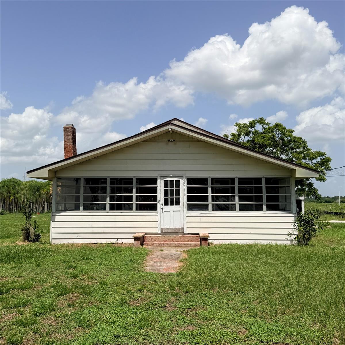 This property is a rare opportunity, 1.32 acres, agricultural zoned with a single family home. C/H/A unit installed 2022, roof 2017, not in a flood zone. Fenced yard, shed, well & septic. Mature landscaping, grand oak, banana trees. This property is a great opportunity to start an organic farm or park your heavy equipment. There are many possibilities. A MUST SEE.