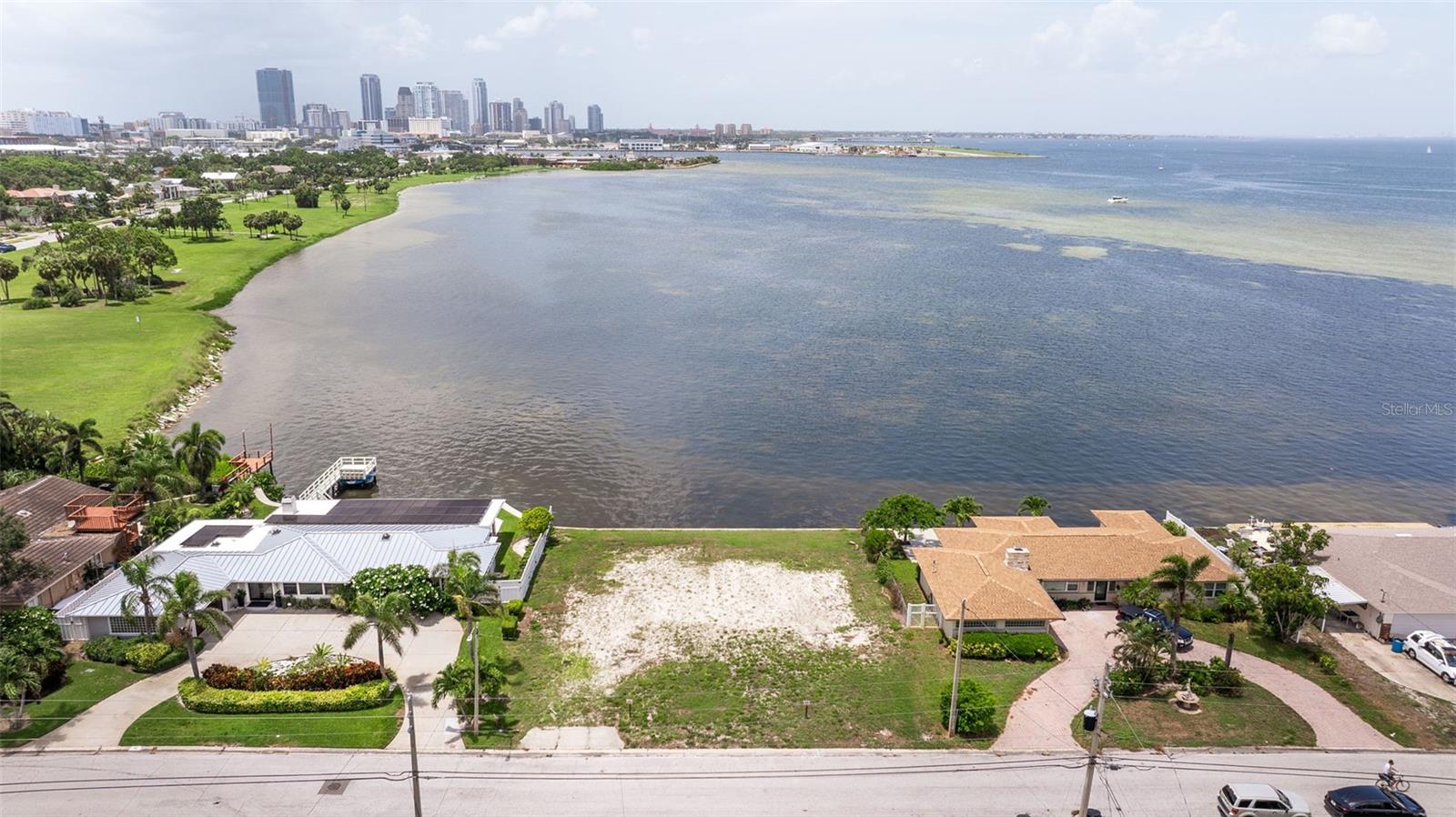 Welcome to your very own slice of paradise in the delightful Tropical Shores! This rare lot is a canvas just waiting for your dream home masterpiece, boasting breathtaking panoramic views of the ever-evolving downtown St. Petersburg skyline. Imagine sipping your morning coffee while soaking in the magical sights of marine life and vibrant birds that come to visit you daily—it’s like having a front-row seat to nature’s own spectacular show! This generous lot measures an impressive 100 feet deep and 90 feet wide, offering you ample space to let your imagination run wild. Want to add a dock? You sure can! Check with the City of St Petersburg for permitting rules. (Just a heads up, no boat lifts allowed). You can however launch water crafts such as kiteboards, paddleboards, kayaks, canoes etc. And let’s not forget Lassing Park, stretching majestically over 14 acres, with fishing spots, kiteboarding, and surfing launch areas right at your fingertips. Picture this: your backyard is an open invitation to all the wonders of the outdoors! So, what are you waiting for? Grab your ideas and sketch out that dream home you’ve always wanted. Schedule your private viewing today and start imagining the incredible lifestyle that awaits you in this beautiful coastal paradise!
The home that was on the lot was torn down in 2017 just after the current owner purchased it. There is no evidence of flooding as the owner has never lived on the property.