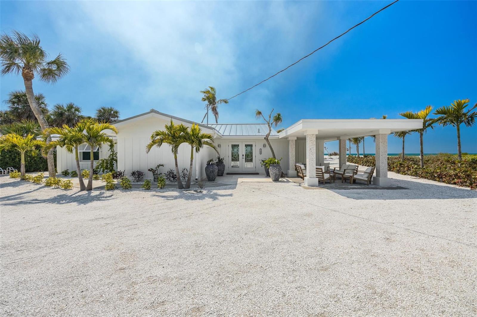 SELLER FINANCING AVAILABLE!—An extraordinary TURNKEY beachfront investment on Manasota Key, this nearly 3/4 acre Gulf-front compound offers approximately 76 feet of private Gulf shoreline, with a 115 ft. deep cushion of your own sand between the homes and the water—preserving your beach, privacy, and views while keeping you just a short stroll to the surf. Designed for both immediate income and long-term appreciation, this is a rare opportunity for the discerning investor. The property features two impeccably renovated, high-performing homes generating over $250,000 annually in rental revenue, with additional upside potential. The primary residence offers 3 bedrooms, 2 bathrooms, and 1,799 square feet, while the second home includes 2 bedrooms, 2 bathrooms, and 1,181 square feet—each thoughtfully designed to accommodate up to 8 guests. Extensive capital improvements ensure durability and peace of mind, including 26-gauge rust-proof aluminum metal roofs (40–50 year lifespan), new 2025 HVAC systems, impact-rated turtle glass, spray foam insulated concrete construction, on demand water heaters, and fully updated electrical and plumbing systems. Interiors are finished to a luxury standard, featuring Taj Mahal quartzite, artisan-crafted ceilings, integrated surround sound, and premium fixtures throughout. Both homes are offered fully furnished, delivering a true turnkey, business-ready asset. A rare convergence of beachfront scarcity, strong cash flow, and flexible acquisition terms for the savvy luxury investor seeking immediate returns. A proven income-producing asset with large potential. These residences are just 1.5 miles from the main Englewood Beach and restaurants. This is a rare opportunity to secure a high performing, turnkey beachfront asset, so call today.