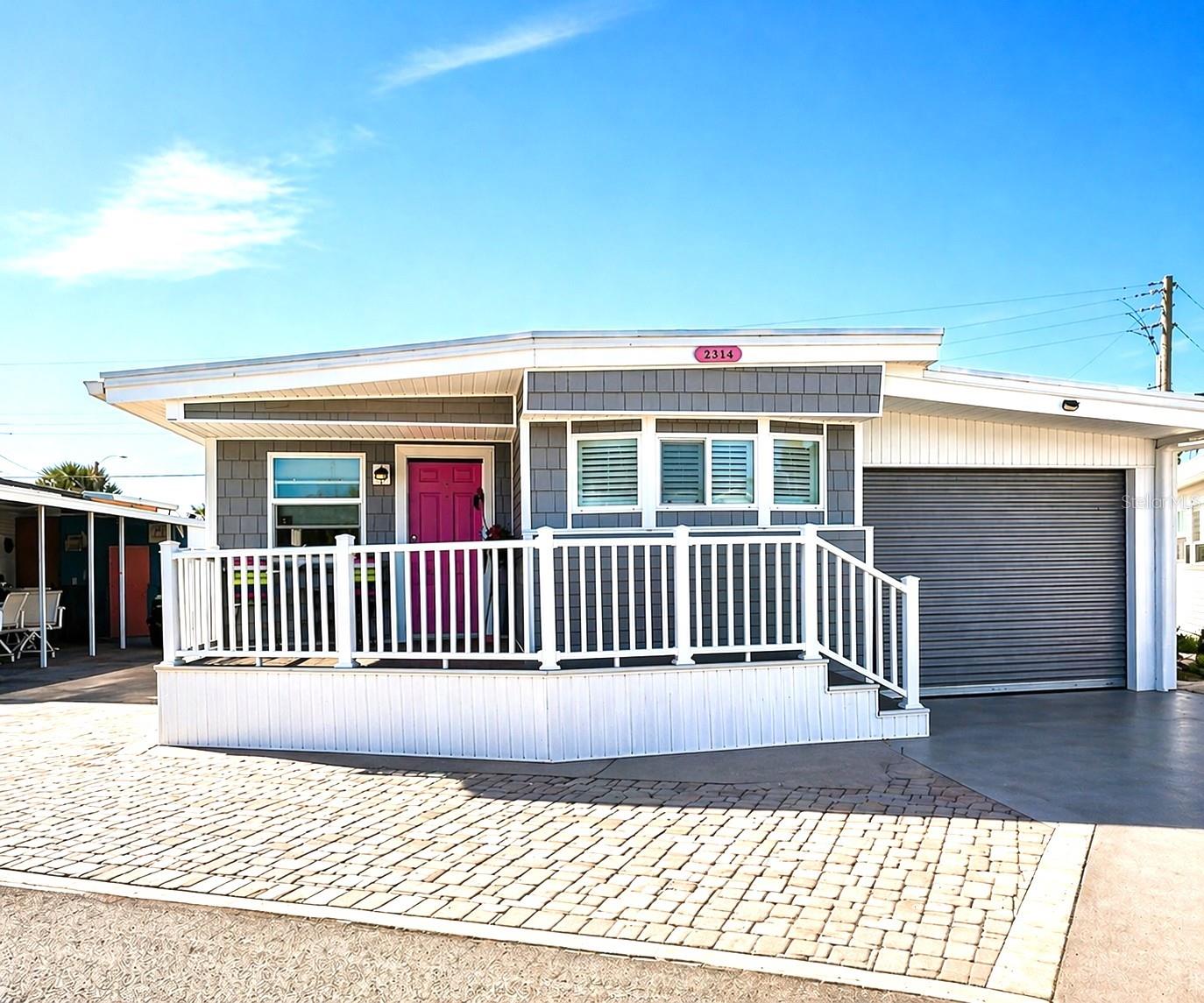 This charming 2-bedroom home features a roll-down garage door leading into a secure, block-constructed carport with metal gates and an epoxy floor—creating a rare and highly functional space for vehicle storage, golf carts, and everyday living. The block design provides privacy and protection and leads to a dedicated half bath and combined laundry area.

Inside, this beachside cottage offers warmth and personality throughout. Plantation shutters, updated flooring (approximately 3 years old), and thoughtful details create a comfortable coastal feel. The primary bedroom features California Closets (2025) with a king bed. The spacious guest bedroom has a queen adjustable bed. The home is being sold furnished, including a fun yellow beach bike.

While the home features one full bathroom inside, additional conveniences include an outdoor shower room and a separate half bath located within the block utility structure.

Outdoor living is equally inviting, with gorgeous paver areas in both the front and back, an elevated front porch with railing and charming shaker-style accents, and a private rear patio perfect for relaxing or entertaining.

Additional updates include A/C (2019), ductwork and blower (2025), and a concrete pad beneath the entire home.

Located in Trailer Estates, a Special Park and Recreation District governed under Chapter 418, Florida Statutes, residents own their land so there is no lot rent, CDD, or HOA fees. The annual park tax covers cable, high-speed internet, trash pickup, fire and rescue services, and access to outstanding amenities, including a marina with rentable boat slips, private beach, pool, hot tub, fitness center, shuffleboard, bocce ball, pickleball, woodshop, and nearly 60 active clubs and social events. Experience one of Sarasota Bay’s most vibrant and welcoming 55+ communities.