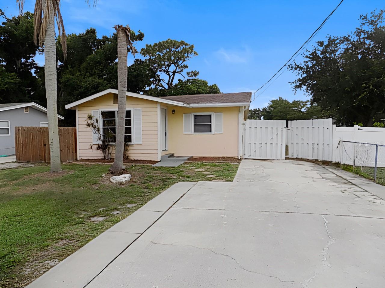 PRICE IMPROVEMENT!! Adorable cottage-style 2-bedroom, 1-bath home offering 1,043 sq. ft. of comfortable living space. This charming property features both a living room and a family room, providing plenty of room to relax and entertain. Situated on a large fenced lot, the home also includes a spacious detached building with water and electric, currently used as a laundry room, with ample space for storage, hobbies, or all your recreational toys. Conveniently located just 5 miles from Siesta Key Beach, this property offers the perfect combination of cozy cottage charm, outdoor space, and easy access to one of Florida’s most beautiful beaches.