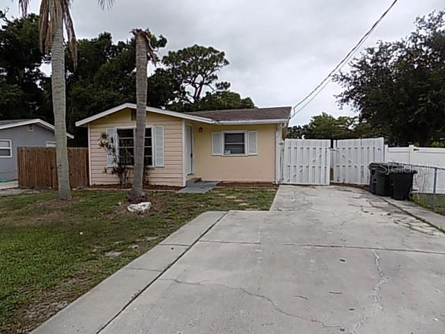 Adorable cottage-style 2-bedroom, 1-bath home offering 1,043 sq. ft. of comfortable living space. This charming property features both a living room and a family room, providing plenty of room to relax and entertain. Situated on a large fenced lot, the home also includes a spacious detached building with water and electric, currently used as a laundry room, with ample space for storage, hobbies, or all your recreational toys. Conveniently located just 5 miles from Siesta Key Beach, this property offers the perfect combination of cozy cottage charm, outdoor space, and easy access to one of Florida’s most beautiful beaches.