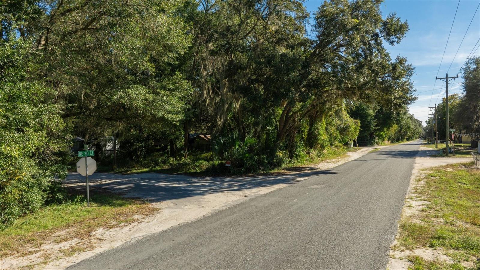 DON'T MISS IT!! - 0.38-acre wooded lot in the Meadows Unit 2 subdivision in Citra, Marion County, with county-maintained dirt road access via NE 164th Lane, level flat terrain, and a rectangular layout measuring approximately 149 by 110 feet. The parcel sits outside city limits, outside any designated flood zone, and provides a straightforward starting point for a future residential build. R-4 Mixed Residential zoning is one of Marion County's more flexible residential designations and supports single-family homes, two-family structures, and both single and double wide manufactured and mobile homes. Tiny homes are allowed. Minimum residence size for this zoning is 1,200 square feet. Short-term and vacation rentals are allowed subject to state guidelines. Camping is not permitted. RV use on the property is allowed during active construction for temporary living and storage. Building permits are valid for one year and can be extended. No HOA. Setbacks are 25 feet front, 25 feet rear, and 8 feet sides. Annual taxes approximately $132.22. Parcel number 0742-012-053. Utilities follow standard rural Marion County setup. Power is available nearby; buyer to confirm provider and connection costs. A well will need to be installed for water. A standard septic system will need to be installed; buyer to confirm availability and cost. Buyers should verify all utility connection details independently. The property is located along NE 164th Lane with direct access to US-301, connecting to Citra, Ocala, and Gainesville. Citra center is about 8 minutes away for basic needs. Ocala National Forest is approximately 20 minutes out. Indian Lakes State Forest Campground is about 25 minutes away. Ocala is roughly 30 minutes for expanded shopping, healthcare, and services. Gainesville is about 40 minutes. Jacksonville and Orlando are each approximately an hour and 45 minutes away, and Tampa is roughly 2 hours and 10 minutes, placing this parcel near the geographic midpoint of the state with efficient travel routes in every direction. The land's tree cover allows for selective clearing and flexible driveway and home placement. Marion County's central Florida location provides year-round outdoor access to state parks, freshwater lakes, trail systems, and recreation areas throughout Marion and Alachua counties. Marjorie Kinnan Rawlings Historic State Park and The Canyons Adventure Park are both within short driving distance. Owner carry options available.