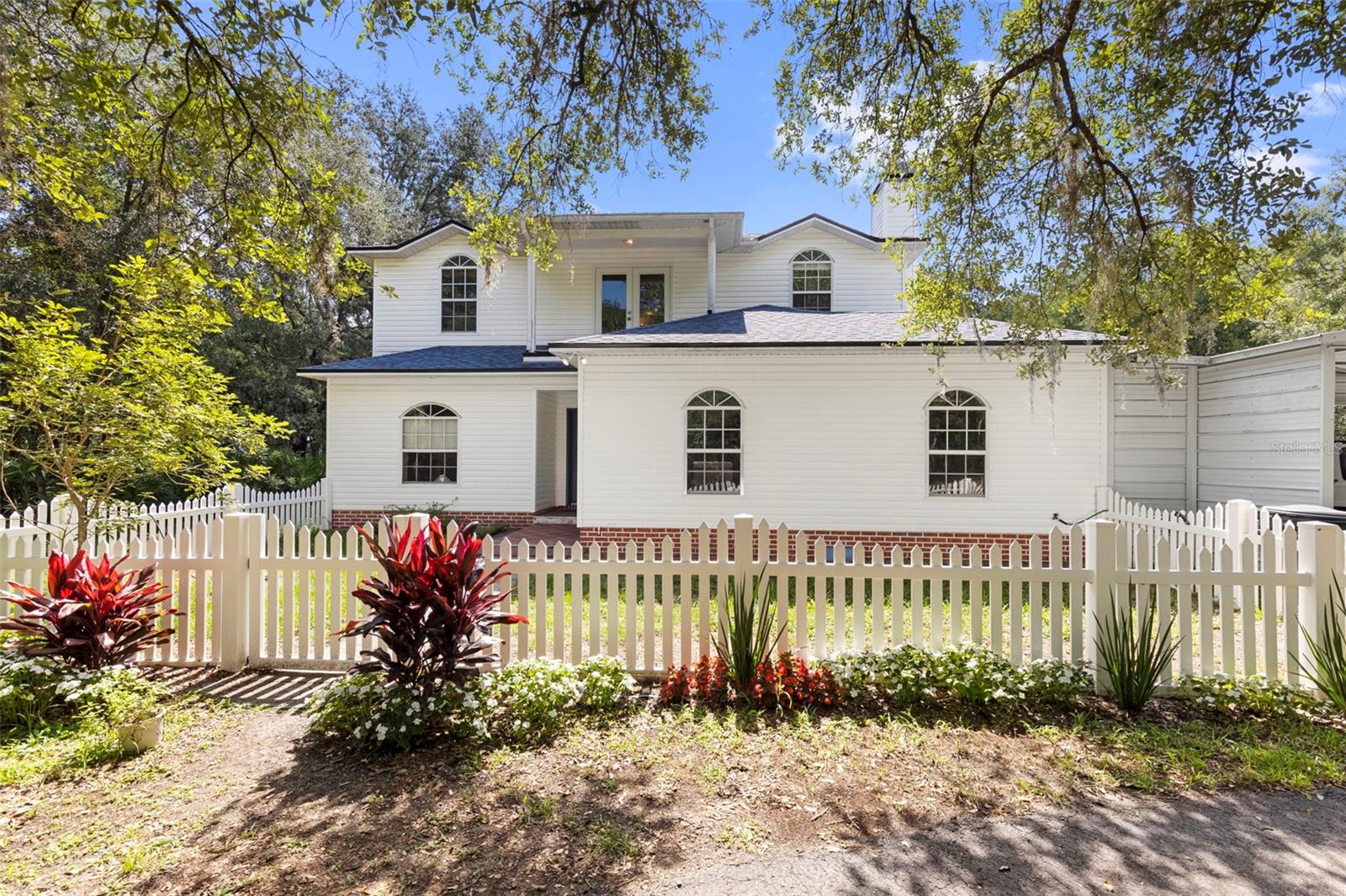 Virtually Staged. Welcome to this stunning Colonial-style pool home offering 3 bedrooms, 3 bathrooms, and 2,027 square feet of living space on nearly 3 acres in Zephyrhills. Complete with a 1-car garage and 3-car carport, this property combines timeless character with modern updates, all with the freedom of NO HOA and NO CDD fees.

As you approach the property, you are immediately captivated by the majestic oak trees that line the driveway, creating a serene and welcoming approach to the home. The circular driveway welcomes you home while beautifully maintained landscaping and fencing enhance the property's impressive curb appeal. • Fence installed (2012) • Carport added (2018) • Driveway paved (2019) • Driveway sealed (2022)

A covered entryway and elegant glass-paneled front door lead you into a light-filled interior where natural light flows effortlessly throughout the home. The first floor begins with a spacious foyer, with the formal dining room conveniently located just adjacent. Also located on the main level is a full bathroom and an inviting family room featuring a wood-burning fireplace creating the perfect gathering space.

The kitchen serves as the heart of the home and is designed for both functionality and entertaining. Featuring abundant cabinetry complete with a built-in bread box, beverage storage slots, decorative glass cabinet panels, extensive countertop space with seating, a dedicated workstation area, and a large walk-in pantry, this kitchen offers everything needed for daily living and hosting guests. The kitchen is complemented by updated appliances including a refrigerator, stove, and dishwasher (2024) and flows seamlessly into the living room, highlighted by recessed lighting and French door access to the outdoor living area.

As you ascend the staircase to the second floor, the spacious primary suite features dual walk-in closets and an en-suite bathroom complete with a soaking tub and expansive glass-paneled shower. Just down the hall is a versatile loft/bonus area, a full third bathroom, and two secondary bedrooms, one featuring built-in shelving and a workstation. Both secondary bedrooms offer spacious closets.

Step outside and enjoy Florida living at its finest. The covered seating area overlooks the screened pool, creating the perfect setting for relaxing or entertaining while taking in the endless views of the surrounding acreage. The sprawling property offers privacy, tranquility, and room to enjoy the outdoors (rear portion of property on three sides is fenced.) With nearly 3 acres, there's ample space for recreational vehicles, boats, equipment, gardening, animals, or future expansion opportunities.

Notable Updates & Features: • Roof replaced (2022) • Termite protection retreat completed (2022) • Carbon filter installed (2019) • Upstairs HVAC replaced with a 15.2 SEER system (2025) • Downstairs HVAC replaced with a 15.2 SEER system (2025) • Septic system pumped (January 2025).

Offering the perfect blend of charm, functionality, acreage, and freedom from HOA and CDD restrictions, this exceptional property is ready to welcome you home.