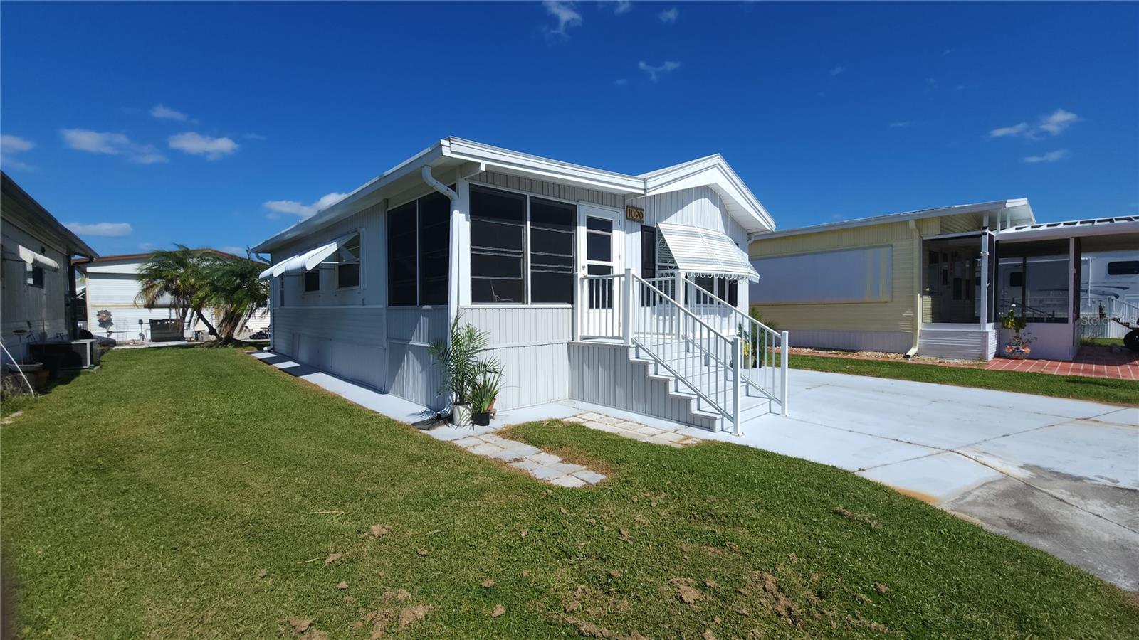 PRICE REDUCTION! This delightful TWO BEDROOM, one bath mobile home is ready for you to move right in and start enjoying the active 55+ lifestyle. The interior showcases charming, on-trend decor and durable vinyl flooring that is both stylish and easy to maintain.
The efficient, eat-in kitchen features modern stainless steel appliances and a moveable prep-island. 
Outside, the enclosed front porch offers a lovely, protected space to relax and soak up the sun. The two cozy bedrooms and the split floor plan layout offer privacy for a visiting guest, or a separate place for a home office or hobby space. There is an attached shed with laundry that can be accessed directly from the primary bedroom. You'll stay comfortable in every season thanks to the new (2025) central A/C and ductwork. The plumbing has also been updated with Pex, providing peace of mind for years to come. Sugar Creek Country Club has LOW HOA FEES OF $600 each QUARTER which include internet, cable, grass mowing, water, sewer and trash. There are two swimming pools, heated spa, clubhouse, tennis, pickleball, shuffleboard, a fitness room, and workshop. There is an active social calendar during the winter months. Enjoy this community's proximity to the River Links Golf Course and the Braden River. SO MUCH TO OFFER! Sorry this is not a dog lot.
