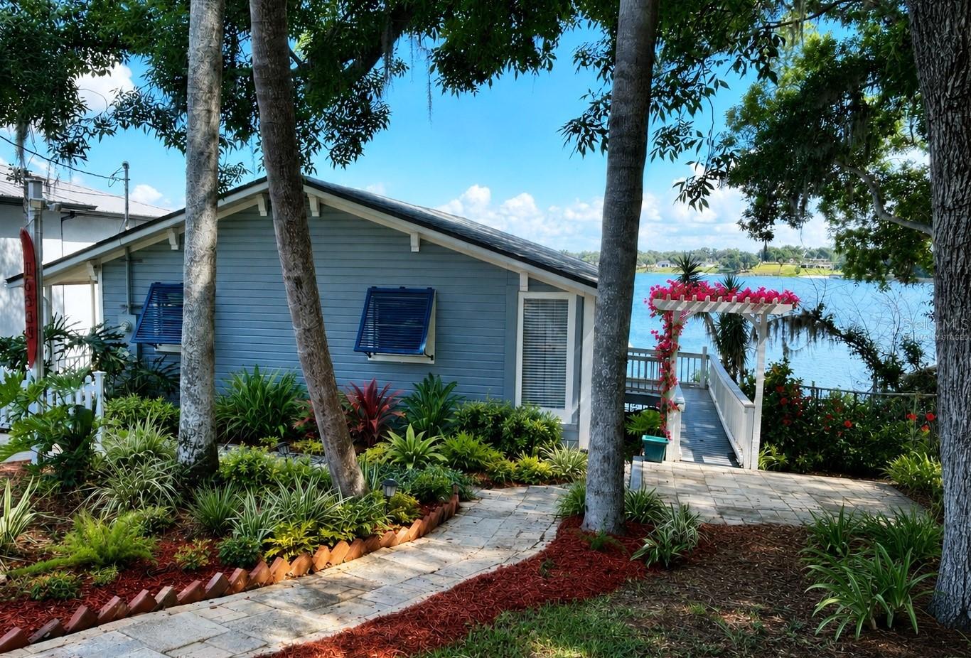 Price Reduced!  This fully renovated 2-bedroom, 1-bath cottage blends modern comfort with Old Florida charm and offers lakefront lifestyle along with strong proven income on a highly desirable private  lake featuring TWO maintained slalom courses—perfect for serious skiers or anyone who loves life on the water. New roof 2025, new windows 2021, updated bathroom, new appliances 2020, and low-maintenance composite wheelchair accessible main entry ramp.  Ideal for first-time lakefront buyers, downsizers, or a peaceful retirement
• Turnkey & Updated: New roof, Upgraded electric 150 amp service, energy-efficient windows, new flooring and appliances, updated bathroom, and new wheelchair accessible ramp decking.
• Lake Life Ready: 43 feet lake frontage with dock/covered boat lift. 
• Income Producer: Currently featured as a proven short-term rental averaging $50,000–$60,000 gross revenue annually
• Outdoor Living: Spacious lakeside overlook screened in deck ideal for sunrise coffee or sunset entertaining.  Hot tub on the lower deck!  Fire pit!  Paddle boards and Kayaks!
• Minutes to world-renowned Montverde Academy
• Close to Bella Collina’s world-class golf, Clermont’s charming waterfront dining and world champion recreation.  Enjoy Lake County’s newly expanded bike trails, and the natural beauty of the surrounding hills
• Close to newly developed medical, retail and dining experiences.
This property is equally suited as a primary residence, vacation retreat, or high-performing short-term rental, offering lifestyle appeal and investment confidence.  Showings by appointment only.