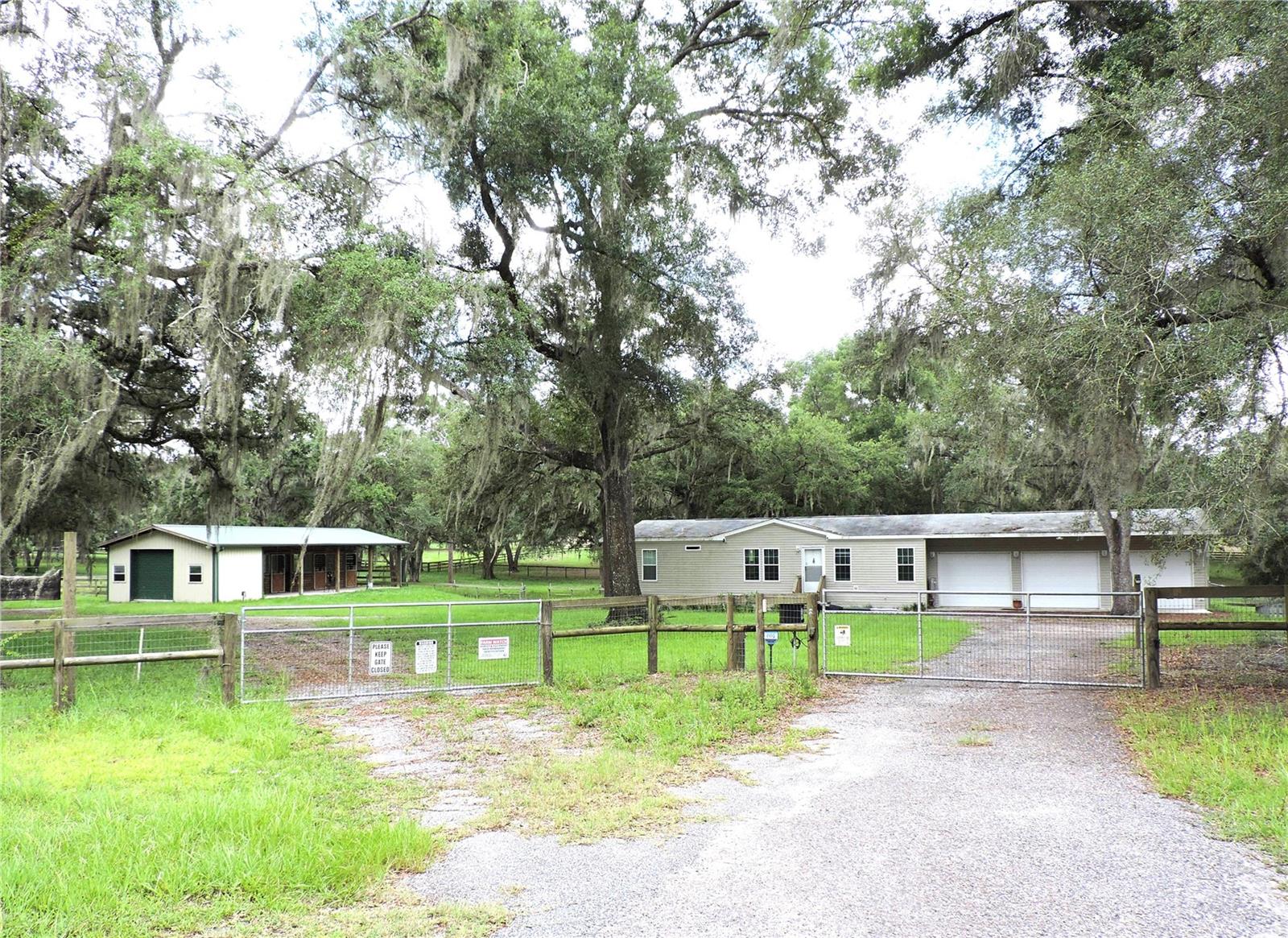 PRIME HORSE PROPERTY! Ride across the street to the Equestrian Trail entrance to the Withlacoochee State Forest! 5 acre property zoned AG, fenced, x-fenced with no climb fencing, gated, on a paved road and ready for you and your horses. This home has 2BR, 2BA, attached 3-car garage, and includes an office, indoor laundry, screen enclosed porch, new upgraded a/c in 2023, island kitchen, built in 2018, move in condition. There is a carport for equip storage, trailers or parking an RV. The 20x60 barn has 3 stalls, separate tack room and feed room with rollup door, water and electric. All stalls have run out paddocks. There is a convenient wash stand and a run-in shed. 4 pastures with scattered oaks for shade. Check it out today!
