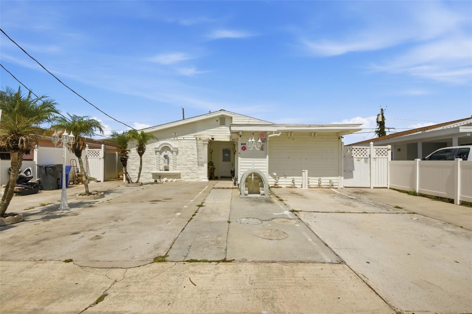 This home is prepared and set for a multigenerational family. The floor plan is divided in which one family would have access to the front part of the house and the back of the home. There is a a separate room in the front that that doesn't have access to the main home but can easily be converted to a living space for additional rental income. The main part of the home has four bedrooms. The second part of the home towards the back has two additional bedrooms and bath with its own entrance. The center of the home has the common area laundry room. The exterior of the home has side walks and the driveway fits 3 cars easily. The home is located near the best parts of Tampa. Significant locations are  9 minutes from Publix and Walmart, 5 minutes from Veterans Express, 12-15 minutes from Downtown Tampa, 15-23 minutes from Tampa International Airport, 20 minutes from International Mall, 10-12 minutes from St. Joseph Hospital, 15 minutes from Tampa General Hospital, 25-34 minutes from the front gate of MacDill Air Force Base. 14 minuts from Moffit Cancer Center, 33 mintues from Saint Peterburg, 34-40 minutes from Bayfront Hospital & John Hopkins Hospital.