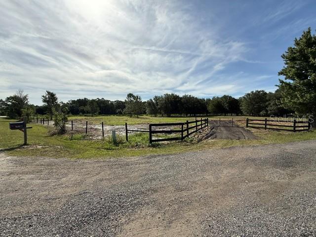 5 acres in South Lake County off Highway 33 and Oil Well Road. Escape the crowds and enjoy the privacy of country living. NO HOA, so bring your toys, horses, cows or whatever… Property is road accessible, 100% all buildable and ready for your dream home, farm, or other projects. Property is fully fenced with recessed gate to help with trailers. All shopping such as Publix and Walmart are within 15 mins conveniently close to local amenities. 30 mins to Disney and theme parks. Spectrum is working on the internet in this area - check with them for more details. This property is incredible with beautiful mature trees, flat land, and looks like a mini park. All closing cost paid. Let's talk about how to get you some land. Thank you. Buyer to verify zoning, utilities, and intended use. Listing is for land only and comes As Is. Street addresses can be for listing purposes only and vacant land will receive a true street address once improved.