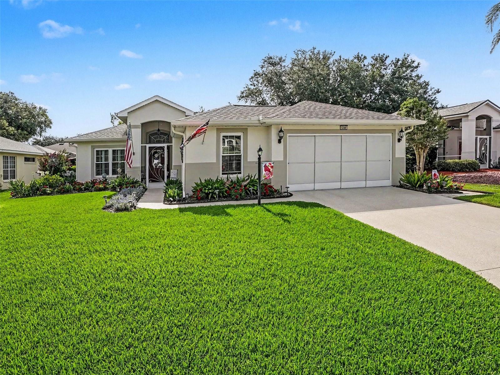 Beautifully landscaped and lovingly maintained, this Royal Harbor home welcomes you from the moment you arrive. Set within a 55+ gated waterfront community on the Harris Chain of Lakes, this move-in-ready 3 Bedroom, 2 Bath home offers the look and feel of a model home, with thoughtful upgrades inside and out. Gorgeous gardens, Shark Coating on the driveway, walkway, and front porch, and true pride of ownership set the tone. Inside, you will appreciate 1,844 sq ft of heated living space, LVP Flooring, Plantation Shutters throughout, including Plantation Slider Shutters, and tasteful updates chosen with care. Home cooks will appreciate the beautifully updated Kitchen with Quartz Countertops, stylish Backsplash, High-End Stainless Steel Appliances, including a Gas Range with Double Oven, and a substantial High-End Island with Slide-Out Extension for added prep and serving space. The Kitchen opens through French Doors to a Covered and Screened Front Courtyard Patio—perfect for grilling, morning coffee, or casual outdoor dining. The Great Room and Primary Suite both open to the spacious Screened Lanai with Sliding Vinyl Windows, creating a comfortable year-round Garden-View retreat. Though not included in the heated square footage, the Lanai lives like an extension of the home and adds wonderful usable space. The Primary Bath has been tastefully updated, including Quartz Countertop, Cabinetry, Fixtures, and Walk-In Shower. Major updates include HVAC in 2024, Roof and Gutters in 2020, Double-Pane Windows in 2021, Exterior Paint in 2023, updated Baths, and so much more. The 2-Car Garage includes a Workshop Area with space for the included Golf Cart. With most furnishings and the Golf Cart included, and only a few seller exclusions, this tastefully decorated home offers a wonderful move-right-in opportunity for seasonal or full-time living. Royal Harbor offers a Clubhouse, Social Hall, Jr. Olympic Heated Pool & Spa, Fitness Center, Craft & Game Room, Billiards, Pickleball, Tennis, Bocce, Shuffleboard, Community Dock, and included RV/Boat/Trailer Storage. Welcome Home!
