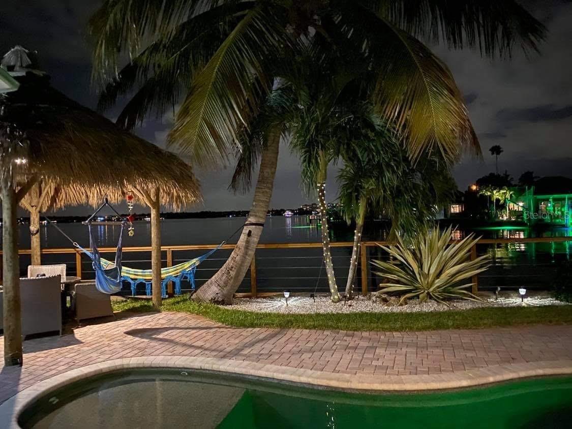 PRICE IMPROVEMENT!!!!....LOCATION IS EVERYTHING...If you are looking for BREATH TAKING UNBELIEVABLE VIEWS with EXPANSIVE OPEN WATER VIEWS on the INTRACOASTEL...THIS IS IT!  The 3 bedroom, 2 bath SPLIT FLOOR PLAN is located on one of the most beautiful lots in REDINGTON BEACH.  The home experienced damage from hurricane Helene, giving the new owner an opportunity to repair or redevelop, adding your personal touches to make it your very own.  ***THIS PROPERTY HAS BEEN DEEMED NOT SUBSTANIALLY DAMAGED***Significant upgrades have already been done.  NEW ROOF 2023, NEW DOCK 2024 with a 10000 LB BOAT LIFT.  This oozes with OLE SOUTHERN CHARM, starting with the expansive front porch.  OPEN FLOOR PLAN , 3 SETS OF FRENCH DOORS leading out to the magnificent pool area where you will enjoy countless hours of relaxation and entertaining around the TIKI BAR!  The seller has a current appraisal which significantly raises the value for the FEMA 50% rule.  Imagine yourself living in this quant southern charm with your personal touches.