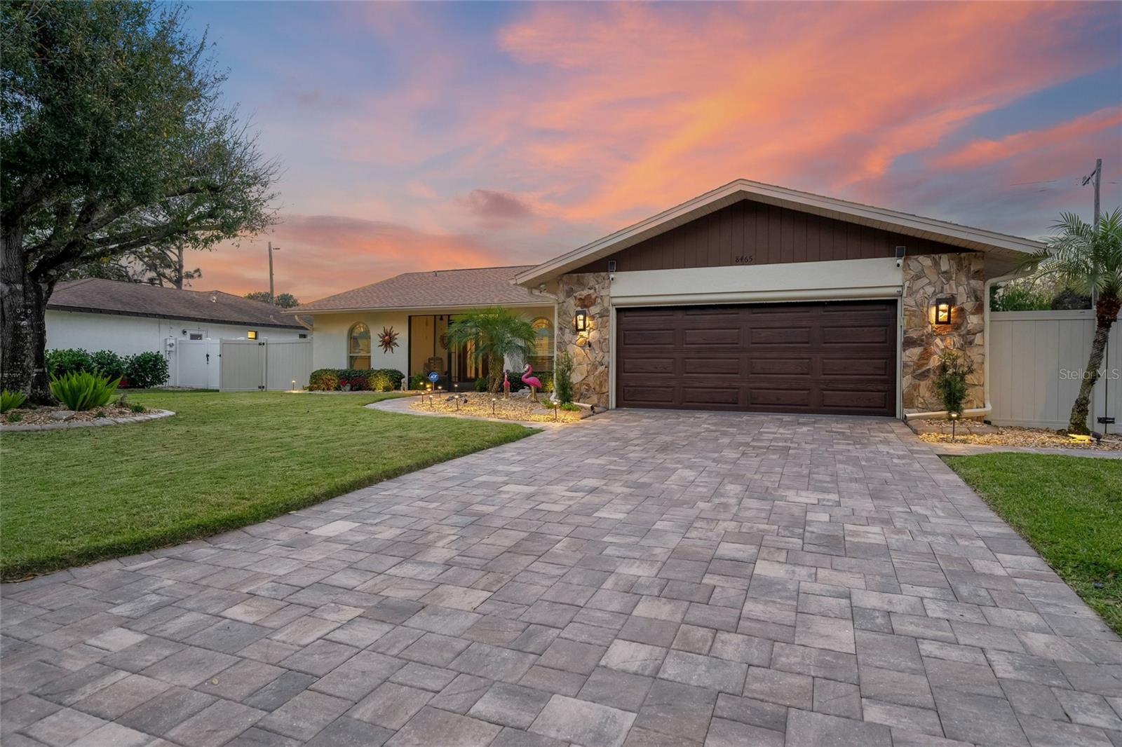 Welcome to 8465 Cypress Lake Circle, a move-in-ready home tucked away on a quiet street. This vibrant residence has been thoughtfully transformed over the years with numerous updates, including impact windows throughout, a remodeled kitchen and bathrooms, updated interior flooring, and outdoor pavers. No detail has been overlooked, and pride of ownership shines through at every corner. Enjoy the versatile bonus space of the enclosed lanai, which opens to your private heated pool. The outdoor area has been intentionally designed with pavers, clean lines, and open space, creating an ideal setting for both relaxation and entertaining while in the privacy of your fully fenced in backyard. The oversized garage is an added bonus, featuring newly painted epoxy floors, built-in cabinetry, and a hurricane-rated garage door. Located in the desirable Country Oaks community, residents enjoy scenic walking trails, tennis courts, and a community pool. Ideally situated just 4 miles from UTC and 6 miles from downtown Sarasota, this home offers the perfect blend of convenience, comfort, and lifestyle.