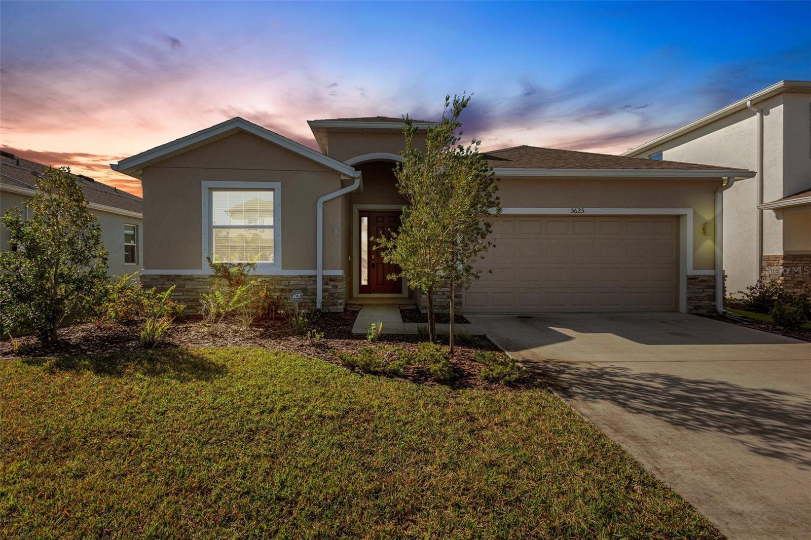 Gorgeous 4-bedroom, 2.5-bath home built in 2020! This immaculate residence offers a generous open-concept floor plan featuring a spacious kitchen that flows seamlessly into the living and dining areas—perfect for everyday living and entertaining. A desirable split layout provides two guest bedrooms at the front of the home, along with a versatile flex room ideal for a den or home office. The expansive primary suite boasts dual walk-in closets, an oversized shower, and a relaxing garden tub. Upgraded large subway tile flooring runs throughout the home and is complemented by beautiful matching stone countertops. The kitchen is well appointed with stainless steel appliances, a walk-in pantry, and stylish cabinetry offering abundant storage. This home blends functionality with modern design and is located in a gated community featuring an impressive community center with a resort-style pool, basketball court, playground, sand volleyball court, and golf cart parking. Low HOA fees, no CDD, and no flood insurance required. Schedule your private showing today!