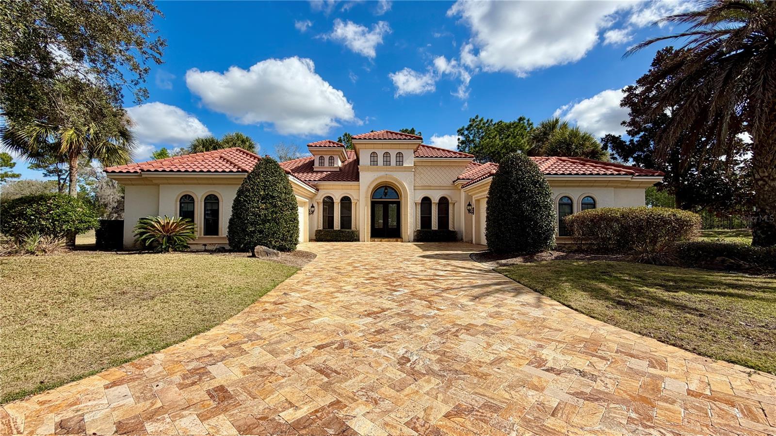 Experience elevated luxury living in this exceptional golf course estate overlooking the pristine green of Hole 10 at the top-rated golf course in the state, Juliette Falls. Built in 2009 and offering an impressive 3,323 square feet of refined living space, this beautifully designed residence combines timeless elegance, thoughtful craftsmanship, and resort-style amenities.

This stunning home features 3 spacious bedrooms and 3.5 bathrooms, with each bedroom offering its own private ensuite—creating the perfect blend of comfort, privacy, and sophistication for both homeowners and guests.

Designed for both everyday comfort and upscale entertaining, the home also includes a private office with beautiful built-in shelving—perfect for working from home or creating a quiet study space. A dedicated dining room offers an elegant setting for formal gatherings and can easily double as a stylish billiard or game room, adding versatility to the home’s thoughtful layout.

At the heart of the home is a gourmet chef’s kitchen designed to impress, showcasing premium Viking appliances, an oversized statement island with abundant seating, and expansive prep and gathering space—ideal for entertaining and everyday luxury living. The open-concept design is complemented by ceramic tile throughout the main living areas, while plush carpeting adds warmth and comfort within the bedrooms.

Step outside to your private resort-style oasis. The expansive screened lanai features a sparkling pool and spa with an elegant water feature, creating a tranquil retreat with breathtaking golf course views. A fully equipped outdoor kitchen transforms the space into the ultimate setting for alfresco dining, sunset cocktails, and unforgettable gatherings.

Additional highlights include a tile roof, split three-car garage - perfect for 2 cars & your golf cart, a GENERAC generator plumbed into the home, full irrigation system surrounding the home, 2 new AC units in the last 5 years, built-in audio systems in the living area, primary bedroom and lanai area, all located on a prime homesite offering sweeping golf course vistas within one of the region’s most desirable communities!

Whether you're seeking a luxurious full-time residence or a sophisticated retreat, this remarkable Juliette Falls luxury home delivers an unparalleled blend of elegance, lifestyle, and location.