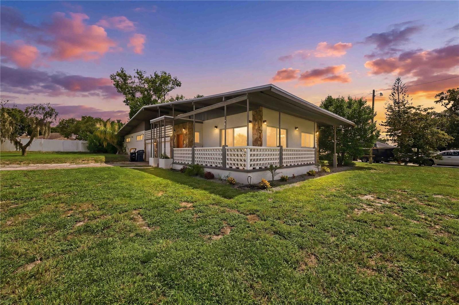 Rarely does a home this unique come to market! Situated on a spacious .30-acre lot directly across the street from beautiful Lake Winterset, this fully renovated 3-bedroom, 2-bath mid-century modern pool home offers incredible character, modern updates, and NO mandatory HOA or CDD. An optional neighborhood HOA of just $100 per year provides access to the community boat ramp, connecting you to the renowned Winter Haven Chain of 22 Lakes, one of Central Florida's premier destinations for boating, fishing, and watersports.
Unlike nearly any other Florida home, this property features an impressive 300+ square foot basement, a rare find that offers endless possibilities as a wine cellar, hobby room, workshop, fitness area, or additional storage.
The home's distinctive architectural design is complemented by spectacular views of Lake Winterset from the living and dining rooms, where sliding glass doors open to a charming wraparound front porch—the perfect place to enjoy your morning coffee while taking in the peaceful lake scenery. Upstairs, a spacious bonus room provides flexibility as a potential fourth bedroom, media room, home office, or second living area and includes a private balcony overlooking the front of the property and the lake.
The beautifully updated kitchen is designed for both everyday living and entertaining with quartz countertops, a center island, pantry, recessed lighting, tile backsplash, reverse osmosis system, garbage disposal, a window overlooking the screened pool, and a premium 2022 Samsung Bespoke appliance suite. The home's thoughtful split layout places all three spacious bedrooms down a private hallway away from the main living spaces. Wood-look tile flooring flows throughout the main living areas, while luxury vinyl plank flooring extends through the bedrooms, bathrooms, and upstairs bonus room.
The spacious primary suite features dual vanities and a beautifully remodeled walk-in shower. Additional conveniences include an indoor laundry closet with the washer and dryer included, and a two-car garage.
Step outside to your oversized screened, chlorinated pool complete with a diving board and removable safety fence, creating the perfect backyard retreat for entertaining family and friends year-round.
Major improvements provide added peace of mind, including a new roof in 2025, a new pool pump and well pump in 2025, new A/C ductwork and attic insulation in 2025, windows replaced in 2019, A/C replaced in 2019, water heater replaced in 2019, and new appliances installed in 2022.
Ideally located just a short drive from Disney, Universal, LEGOLAND, and other Central Florida attractions, this one-of-a-kind home combines timeless mid-century modern architecture, extensive modern updates, a rare basement, beautiful lake views, access to the Winter Haven Chain of Lakes, and a lifestyle that is truly hard to find.
Don't miss this rare opportunity to own one of the area's most distinctive homes overlooking beautiful Lake Winterset.