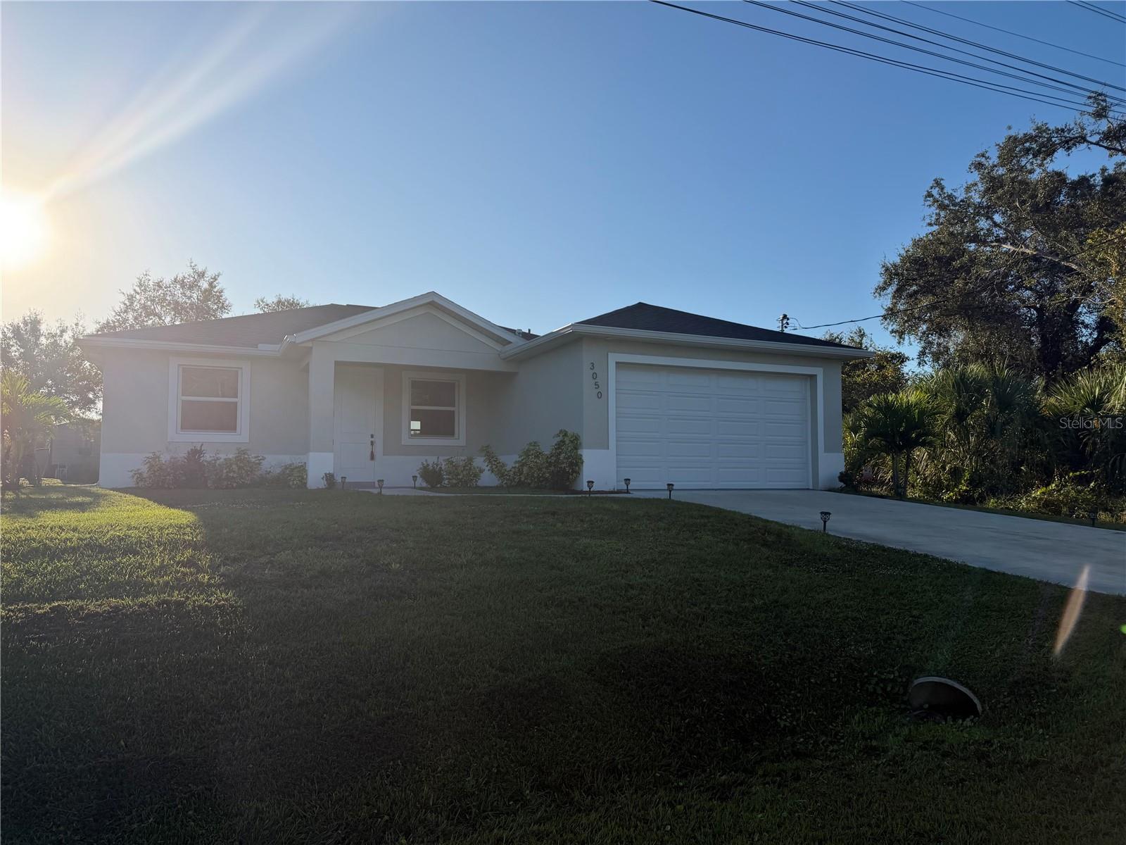 Amazing Rental Find in North Port!  Like-New 3-bedroom, 2-bath home, perfectly situated in North Port while remaining close to everything Port Charlotte and Venice has to offer. This thoughtfully designed residence features durable laminate vinyl plank flooring throughout, sleek hard-surface countertops, stainless steel appliances, and a washer and dryer for added convenience. With just under 1,500 square feet of living space, the open living and dining area is enhanced by 10-foot ceilings and elegant Spanish lace wall finishes, creating a bright and inviting atmosphere. The spacious primary suite boasts a walk-in closet and a spa-inspired bathroom complete with a glass-enclosed walk-in shower, separate soaking tub, and double vanity. Additional highlights include a two-car garage, a quiet low-traffic neighborhood, and a screened-in lanai with frosted panels for enhanced privacy—perfect for relaxing or entertaining. This beautiful home offers the comfort and style of new construction and is ready for you to enjoy. QUICK AND EASY APPLICATION PROCESS.