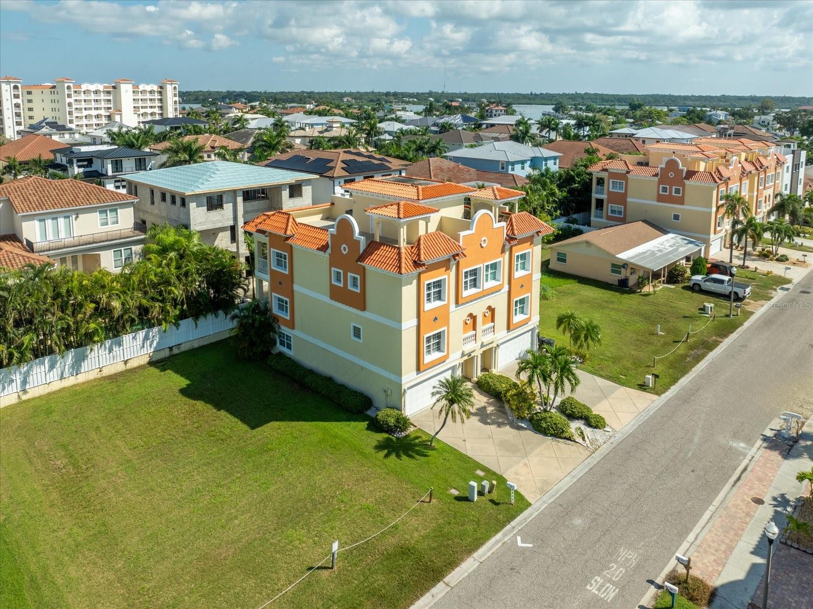This beautiful three-story townhome offers a private rooftop terrace with Gulf views, complete with a covered pergola—perfect for enjoying coastal sunsets. The property has one attached wall with an identical unit on the opposite side and no HOA fees. As the original builder’s model, this home was thoughtfully designed with quality finishes throughout. The kitchen features granite countertops, 42" wood cabinetry, a breakfast bar, and a closet pantry. A private elevator runs from the two car garage to the rooftop terrace, making the home wheelchair accessible. Brazilian cherry wood flooring extends throughout most of the townhome, including the staircases. The living room includes a built-in shelving unit with an electric fireplace, and high ceilings throughout enhance the spacious, open feel. Storage abounds on every level, including multiple storage rooms in the oversized garage. Man cave alert...A large bonus room on the main level with window A/C unit makes an ideal game room, media room, or flex space. Recent updates include a new roof over the elevator and stairwell in 2025, two A/C units installed in 2019, and a 200-amp electrical panel. The kitchen is equipped with a reverse osmosis water filtration system and there is a water softener.
This home offers the ultimate beach lifestyle located just one block from the beach and close to restaurants, bars, and shopping. Spend your mornings or evenings strolling the shoreline or relax on your private rooftop terrace taking in spectacular Gulf sunsets!!