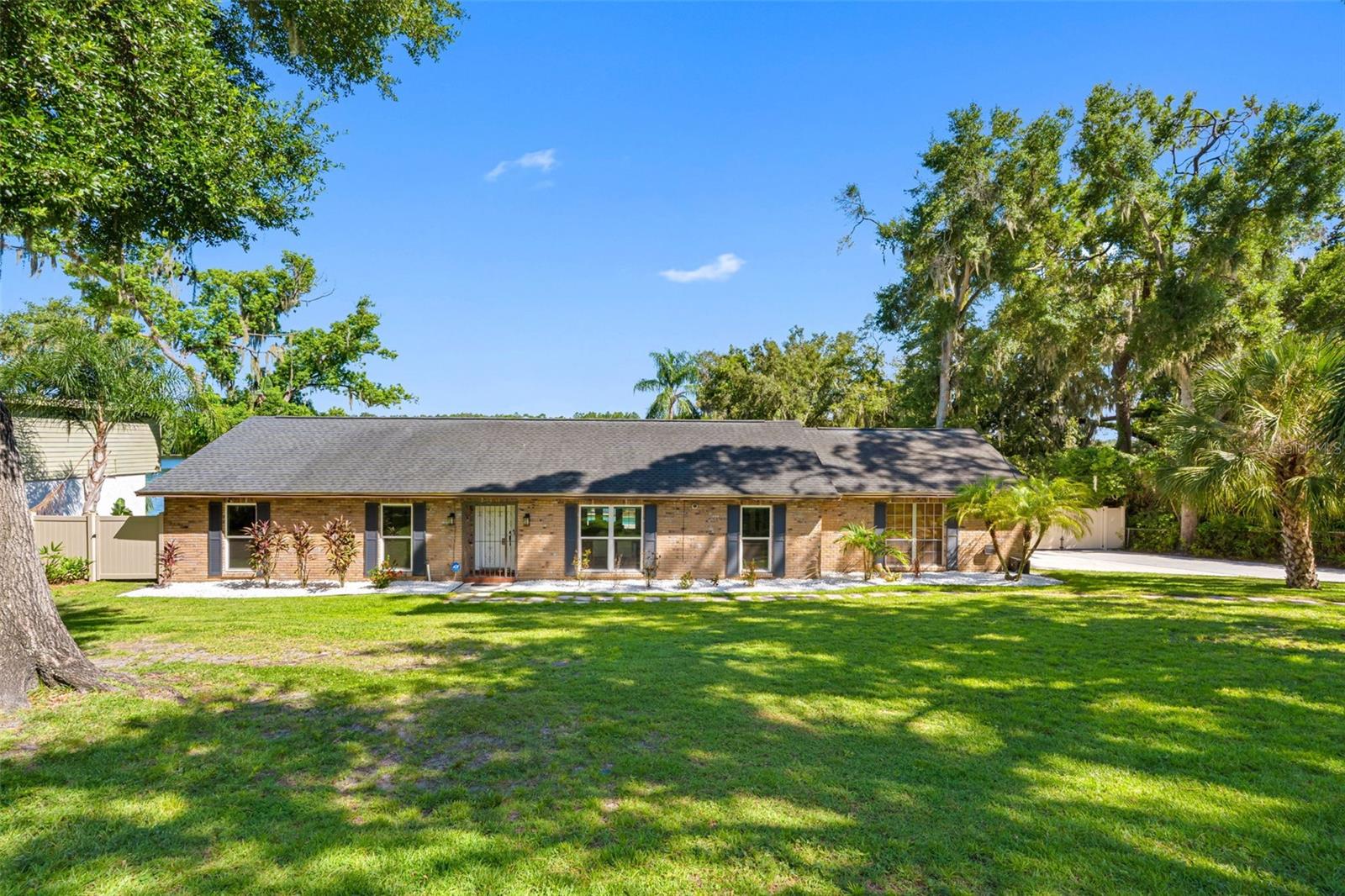 Welcome home! Waterfront living meets timeless design in this beautifully refreshed mid-century style farmhouse. Set on a private 0.35-acre lot with over 100 feet of Hillsborough River frontage, this exceptional property offers a rare opportunity to enjoy peaceful waterfront living just minutes from the heart of Tampa. Located outside the flood zone and unaffected by recent hurricanes, it provides the peace of mind that's becoming increasingly difficult to find. Inside, an open-concept layout is designed to maximize natural light and picturesque river views. The beautifully updated kitchen features white shaker cabinetry, a large center island, granite countertops, stainless steel appliances, a stainless steel range hood, farmhouse sink, and a recently updated backsplash. Porcelain tile flows throughout the home, while the inviting living room is centered around a brick wood-burning fireplace and overlooks both the screened saltwater pool and the Hillsborough River beyond. The primary suite also enjoys tranquil river views and a beautifully updated ensuite bathroom. Designed for effortless indoor-outdoor living, the backyard is a private waterfront retreat. Enjoy a screened, solar-heated saltwater pool with a sun shelf, waterfall, and fountain, a spacious patio for entertaining, a fire pit, composite dock, lush new irrigation, and a fully fenced yard with double gate access for convenient boat or RV storage. Whether you're spending the day on the water or relaxing poolside, this property was made to embrace the Florida lifestyle.
Additional improvements include a 2025 HVAC system, 2017 roof, double-pane windows, fresh interior paint, cosmetic updates throughout, a whole-house water softener, and a spacious two-car garage, making this home truly move-in ready. Whether you're searching for a primary residence, a luxury second home, or an income-producing investment, this property offers exceptional versatility. It previously generated over $100,000 in gross Airbnb revenue in 2019, highlighting its proven short-term rental potential. Ideally located just minutes from Downtown Tampa, Armature Works, Ybor City, Busch Gardens, and some of the area's best dining, shopping, and entertainment, this home offers the perfect balance of privacy, convenience, and waterfront living. Opportunities to own over 100 feet of Hillsborough River frontage outside a flood zone are exceptionally rare. Schedule your private showing today.