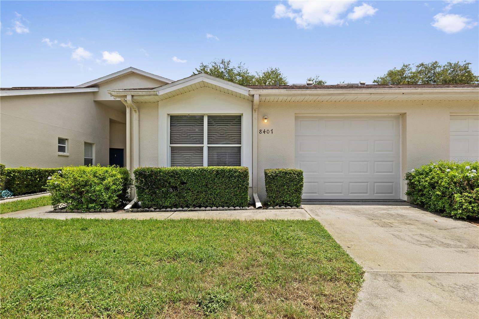 Freshly updated and move-in ready! Welcome to the desirable Meadowoods community! This spacious 3-bedroom, 2-bath condo offers over 1,500 sq ft of comfortable living with a smart split floorplan — the private primary suite is tucked off the living area featuring an on suite bathroom with double vanities and a walking closet, while the two additional bedrooms are at the opposite end, perfect for guests or a home office. The spacious kitchen features bar seating and a pantry, making it as functional as it is inviting. Fresh paint and brand new LVP flooring throughout (June 2026) give this home a crisp, move-in ready feel. Relax on your large screened lanai or head out to enjoy Meadowoods' community pool, walking trails, and tennis courts.