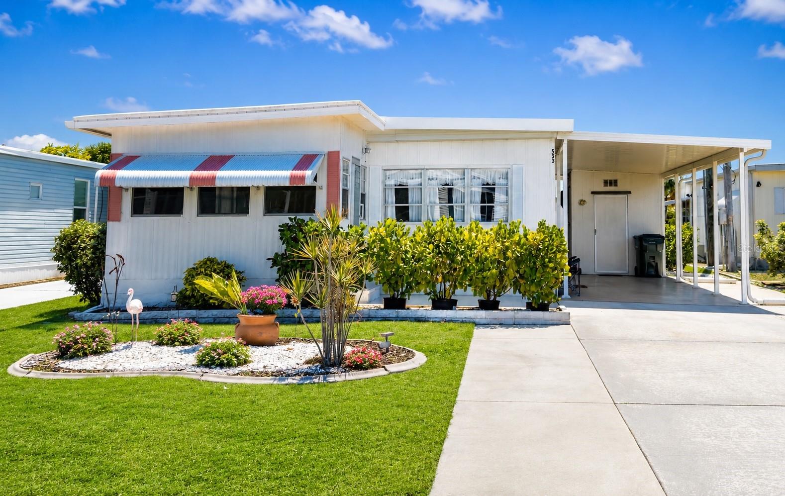 Cute as a button and fully furnished! Move-in ready, priced to sell, and sure to go fast. Experience the best of Florida’s retirement lifestyle; Harbor Cove, a sought-after 55+ waterfront community along the scenic Myakka River, filled with resort-style amenities. This 2 bed/2 bath home, styled with warm, charm, and a clean, modern feel is ready for it's new owner. **Metal Roof, New Carport, HVAC 2020**. Extra-long driveway with additional parking pad, shed, paved patio. Large primary bedroom featuring an ensuite bathroom. Spacious guest bedroom with ample closet space. Welcoming and bright sun room filled with natural light, perfect for morning coffee or comfortably hosting overnight guests. City water and sewer. $99 a year land lease, NO HOA fees, NO LOT rent. Resort-style amenities with two sparkling heated pools, a relaxing spa, a well-equipped fitness center, a clubhouse overlooking the stunning marina, shuffleboard, horseshoes, pickleball, tennis, and bocce courts. Socialize and stay active with dances, parties, water aerobics, fitness classes, art classes, woodworking, golf cart parades, bingo, dances, and more. Boat clubs, a craft room, picnics on the patio, golf clubs, bowling clubs and much more. There is plenty of wildlife to enjoy in this 190-acre community; herons, egrets, cranes, ibis, parrots, even alligators and manatees! Conveniently located within minutes of Downtown Wellen Park, Costco, shopping, restaurants, and a short drive to beautiful Gulf Beaches. Schedule a viewing today and let this dream home become your reality!