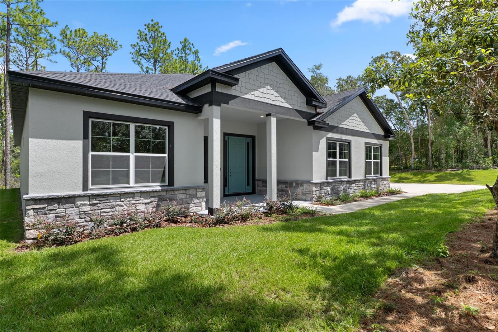 Virtually Staged. Offering preferred lender incentives! Brand new construction in Fairview Estates of Citrus Hills: The 2026 Major Model Awaits! This home is perfectly situated off the street on 1.24 acres with a private backyard that backs up to a dry retention area.  There are 4 bedrooms, 3 bathrooms with 2,478 sq' of living space. This bright and airy home is complete with enhanced neutral finishes that create continuity throughout the space and can accommodate any decor. Low maintenance luxury vinyl plank runs throughout the home - NO CARPET- and elegant marble-like tile in all bathrooms. The kitchen includes a stainless-steel Samsung appliance package, shaker style cabinetry with 42" uppers, dovetailed base cabinets, and everything on soft close! Quartz countertops provide a durable workspace with subway tile as a backsplash accent. The home offers a triple-split floor plan with a dedicated guest wing up front, Jack-and-Jill wing in the rear, and a secluded primary suite - including an extra storage closet, oversized walk-in closet, a luxurious shower, double vanity, and a toilet room. Bathrooms include quartz countertops, Moen fixtures, comfort height elongated toilets, privacy transom windows, and wall tiles up to the ceiling to give a sense of height and grandeur. There is also a dedicated laundry room off of the garage, with a walk-in pantry and extra cabinets for storage. Other features include LED disc lighting throughout, 9'4" ceiling height, and 5.25" tall baseboards. Outside you will find double paned windows, irrigation, and a covered lanai to enjoy the outdoor view of the woods behind with room for a pool. Home sits in flood zone X, with the low HOA fee of $82.50/year and includes a home warranty. There is NO social membership!  Fairview Estates is a part of The Villages of Citrus Hills and is a tucked away gem! All homes come with acre lots, creating a sense of calm, with oak lined streets and a garden atmosphere. Located about 6 miles from the Shops at Black Diamond with restaurants, grocery stores, and shopping. The home is also 1.5 miles from the 47 mile Withlacoochee bike/walking trail! You'll fall in love with this home so schedule your showing today and be ready to submit your best offer!