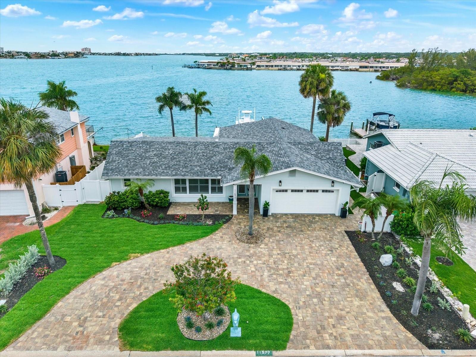 One or more photo(s) has been virtually staged. SOAK UP MAGNIFICENT SUNSET VIEWS FROM THIS WATERFRONT PARADISE OVERLOOKING FANTASTIC BOATING WATER ON THE INTRACOASTAL WATERWAY! This stunning 4-bedroom, 3-bathroom pool home offers breathtaking open water views, direct boating access, and a level of luxury and craftsmanship that is truly exceptional. COMPLETELY RENOVATED FROM TOP TO BOTTOM, VIRTUALLY EVERY ASPECT OF THIS HOME IS BRAND NEW. Following Hurricane Helene, the property underwent an extensive professional renovation, resulting in a beautifully reimagined residence that combines modern design, quality construction, and peace of mind. UPDATES INCLUDE ALL-NEW PLUMBING, ALL-NEW ELECTRICAL SYSTEMS, NEW HVAC IN 2026, QUARTZ COUNTERTOPS, UPDATED BATHROOMS, NEW FLOORING, AND A BUILT-IN BAR AREA WITH PREMIUM WINE FRIDGE! This home also comes with IMPACT WINDOWS AND DOORS (no hurricane shutters needed!), a tankless water heater, laddered attic space in the garage, and a newer water softener. Roof was replaced in 2017. Overlooking the sparkling pool and dreamy water views beyond, the kitchen is full of premium upgrades, including a “hidden” laundry/pantry area that will impress even the most discerning buyers. Disguised as an elegant extension of the kitchen cabinetry, a secret entry introduces a beautifully appointed, multi-functional pantry and laundry room. THE BACKYARD HAS BEEN TRANSFORMED WITH NEW TURF, NEW PAVERS, A NEW FENCE, NEW DECKING, AN OUTDOOR KITCHEN WITH GRILL AND A SMOKER, A RESURFACED POOL, AND ALL NEW POOL EQUIPMENT! Boaters will appreciate the newly updated dock and boat lift (accommodates a 25ft+ vessel) with easy access to the Gulf of Mexico and NO FIXED BRIDGES for boaters to contend with. An irrigation system helps maintain the lush landscaping, while the newly finished epoxy garage floor adds the perfect finishing touch. Located in UNINCORPORATED PINELLAS COUNTY, WITH NO MINIMUM RENTAL RESTRICTIONS, this property presents a rare opportunity as a primary residence, 2nd home, or a luxury vacation rental. Located just minutes from award-winning Gulf beaches, waterfront dining, Seminole City Center, Publix, and vibrant local attractions, this is truly one of the most desirable waterfront locations in Tampa Bay! Rarely does a waterfront home combine breathtaking views, extensive upgrades, boating amenities, resort-style outdoor living, and investment flexibility into one extraordinary package. This is more than a home—it's a lifestyle.