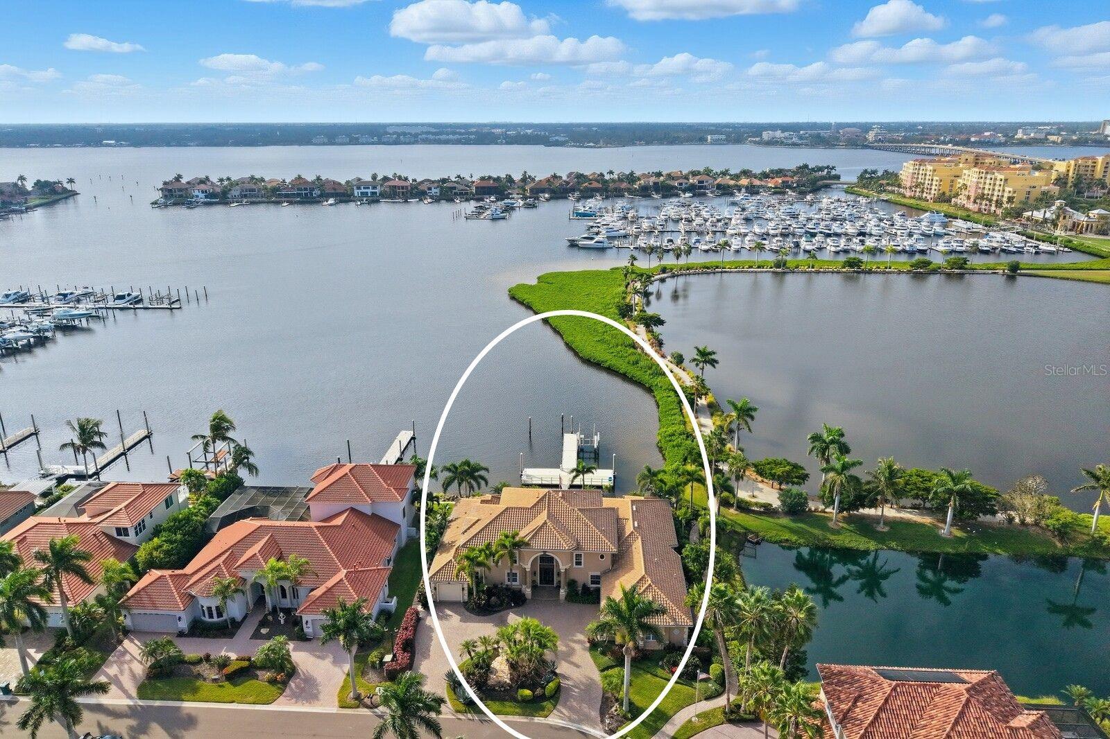 THE CROWN JEWEL OF RIVIERA DUNES- Florida's Gulf Coast's PREMIER yachting community featuring a protected, deep water harbor! This transitional Mediterranean home is truly exceptional and offers over 5,300 square feet of living space, featuring 6 bedrooms plus office, 5.5 baths and 3 car garage and can be purchased turn-key furnished. Every detail of this home reflects fine craftsmanship and artistic vision, with custom finishes, premium materials and absolutely ZERO deferred maintenance. This house has literally been maintained with an open wallet! The main living areas are perfectly laid out for entertaining and socializing. The dining room impresses with a two-story glass wall framing stunning views of the lanai, infinity edge pool, and the harbor. This space is further enhanced by a custom THINKGLASS built-in countertop, and seamless access to a butler’s pantry complete with a wine fridge, wet bar, and pass-through window to the outdoor kitchen. The family room offers a built in whole house entertainment system, 65” LG Smart TV, gas fireplace, and a 4-panel disappearing glass wall that opens directly to the lanai. Tray ceilings, recessed lighting, and surround sound enhance the ambiance. The chef’s kitchen, updated in 2021 by Epoch Solutions, features high-end appliances including a Thermador Wi-Fi-enabled wall oven and microwave, Viking 6-burner gas cooktop, SUB-ZERO built-in refrigerator, Jenn-Air warming drawer, Blanco sink, and Kitchenaid dishwasher. A spacious wraparound island seats six and opens into a glass-walled breakfast area overlooking the water. Wine enthusiasts will appreciate the 56-square-foot climate-controlled wine cellar which houses over 500 bottles and includes a glass display wall & charming old-world tasting area. The primary suite on the main floor offers direct access to the lanai, water views, a tray ceiling with recessed lighting, and oversized his-and-her custom closets. Two additional bedrooms on this level include a guest room with a queen Murphy bed and a dedicated office. Upstairs, a second primary suite offers a private coffee bar, refrigerator, and access to a screened lanai with sweeping water views. Two more upstairs bedrooms share a Jack & Jill bath with individual vanities. Step outside into your private paradise featuring a resort-style infinity-edge pool with spa, outdoor gas fireplace, a custom bronze mermaid fountain with in-pool seating, and an outdoor kitchen with Thermador grill & pass-through. The screened in lanai features a picture window for maximum views & is enhanced with two gas tiki torches and an outdoor shower. For boating enthusiasts, this estate includes a RARE DOUBLE 60-foot slip (one slip open and another has built in lift for a second boat) with a 1,300 sqft floating dock—completely remodeled and expanded in 2021. It is the LARGEST and most updated dock in the community, featuring a 50 AMP power pedestal, two dock boxes, & a folding ladder. Additional features include a 24kW Generac whole-house GENERATOR (2023) with dedicated gas line and transferable 10-year warranty. Conveniently located near 3 Major Airports for ease of international and domestic travel! This home also is near top-tier schools, including IMG ACADEMY, ST STEPHENS AND BRADENTON CHRISTIAN SCHOOL! Only minutes to the Gulf Beaches of Anna Maria Island, short distance to downtown Bradenton & St. Pete, and the cultural & culinary arts of Sarasota. TRULY AN AMAZING LOCATION WITH EASY ACCESS TO SO MANY OPTIONS!