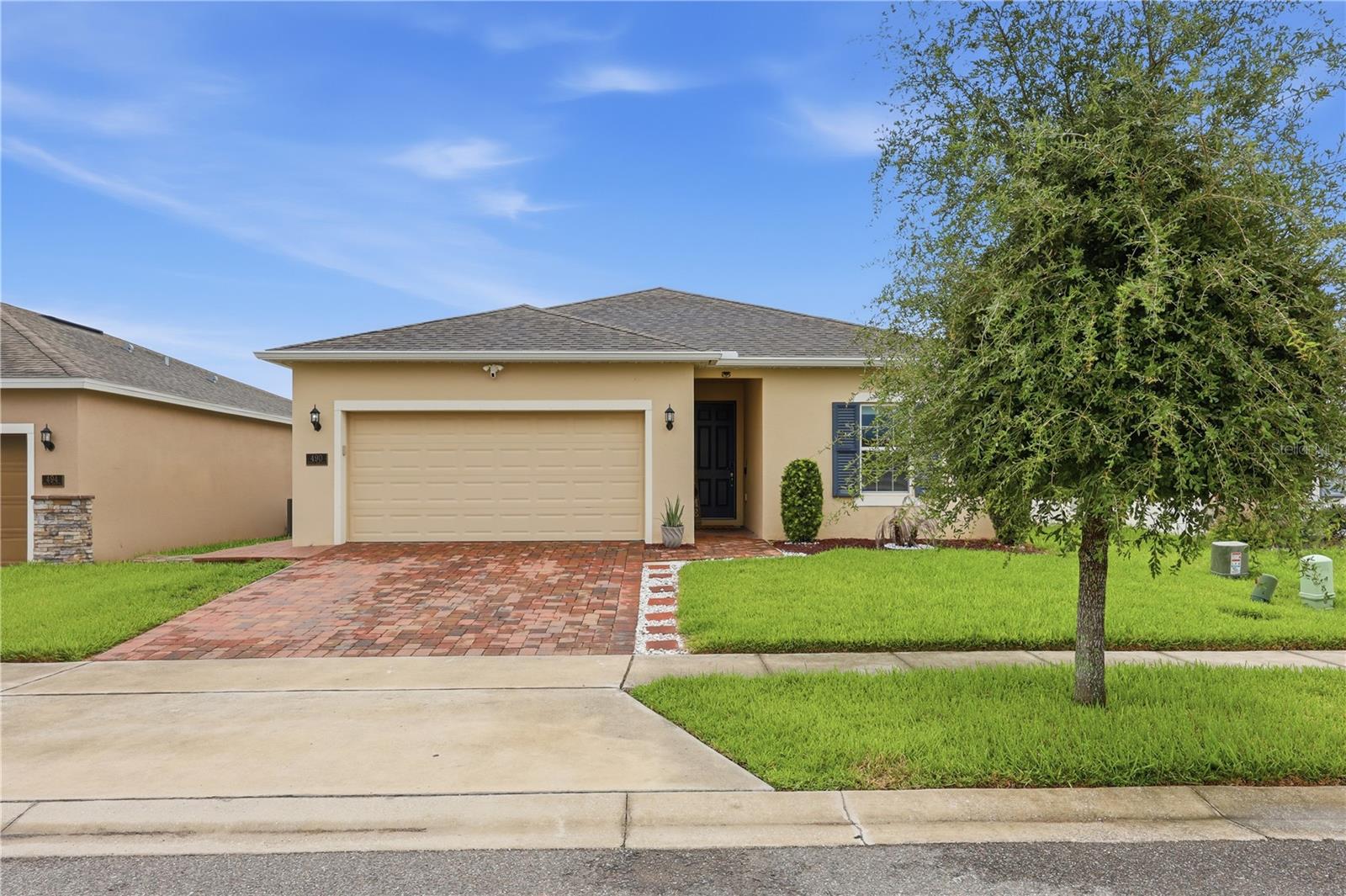 Why wait months for new construction and then spend thousands on upgrades when you can own a home that's already been thoughtfully improved? Welcome to 490 Disa Drive in Orchid Grove, a beautifully upgraded, move in ready home in Davenport, Florida offering features today's buyers are actively searching for. Located in the desirable Orchid Grove community, this home is just minutes from ChampionsGate, Posner Park, I 4, US 27, Walt Disney World, shopping, dining, and everyday conveniences. Whether you're commuting to Orlando, Kissimmee, or Lakeland, you'll appreciate the convenience of this Central Florida location. Inside, durable tile flooring flows throughout the main living areas, while luxury vinyl plank flooring has been installed in every bedroom, creating a completely carpet free home. Contemporary light fixtures throughout give the home a fresh, custom feel. The kitchen has been upgraded with a designer tile backsplash, tiled island, newer refrigerator, and built in beverage refrigerator, creating a stylish and functional gathering space. The primary bathroom features an upgraded vanity sink, while both bathrooms include premium anti fog mirrors. The secondary bathroom has been enhanced with a sleek tempered glass shower enclosure. The laundry room offers a newer stacked washer and dryer, additional storage, and a utility sink for added convenience. Step outside to a fully fenced backyard designed for entertaining, complete with an oversized paver patio, custom pergola, professionally installed LED fence lighting, a paver walkway, storage shed, and playground. Additional upgrades include a whole home water softener system and a Ring security system, both included with the home. An added bonus for qualified buyers is the opportunity to assume the seller's existing mortgage with an incredibly low 2.8% interest rate, offering significant potential monthly savings compared to today's market rates. As a resident of Orchid Grove, you'll also enjoy resort style amenities including a community pool, clubhouse, dog park, and playground. If you're searching for a move in ready home in Davenport with no carpet, designer upgrades, a fenced backyard, modern finishes, and exceptional value over new construction, 490 Disa Drive deserves a place at the top of your list. Every major improvement has already been completed, allowing you to move in and enjoy the home from day one without the added expense of builder upgrades.