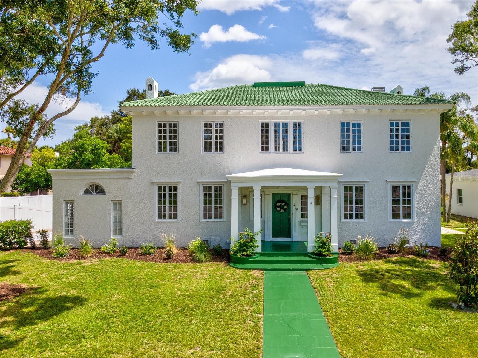 Welcome to this quintessential Belleair estate, a masterful blend of timeless elegance and modern refinement. Thoughtfully restored with exquisite attention to detail, this historic residence sits on a picturesque, palm tree-lined street. Take advantage of the Belleair lifestyle in your personal golf cart and explore all that the community has to offer including world class golf at Belleair Country Club and The Pelican Golf Club, fine dining, shopping and some of America’s most beautiful beaches. Located in a non-flood, no evacuation zone, the estate offers sweeping golf course views, a resort-sized pool, and a spacious driveway with ample room for vehicles. Inside, you are welcomed by custom marble flooring that flows into a grand formal dining room, ideal for family gatherings. An aesthetically pleasing, professionally designed chef’s kitchen awaits just beyond, complete with a butler’s pantry and adjacent powder room. The first-floor primary suite is a true retreat, featuring refinished 20th-century hardwood floors, a pass-through fireplace, a luxurious en-suite with soaking tub, and a walk-in closet with handcrafted wood shelving. Throughout the home, restored original windows provide an abundance of natural light and frame views of century-old palms and manicured fairways. Two versatile flex spaces—one on each floor—offer options for a home office, nursery, or playroom. Upstairs, four spacious bedrooms each have dedicated bathroom access for convenience.  Down a private hallway, a game/media room with half bath provides the perfect secluded entertainment space. Additional highlights include a 400 sq ft living room with wood-burning fireplace and a bright sunroom overlooking the expansive pool and sun deck—an entertainer’s dream. This exceptional property combines history, luxury, and location, offering the rare opportunity to call one of Belleair’s true legacy's home.