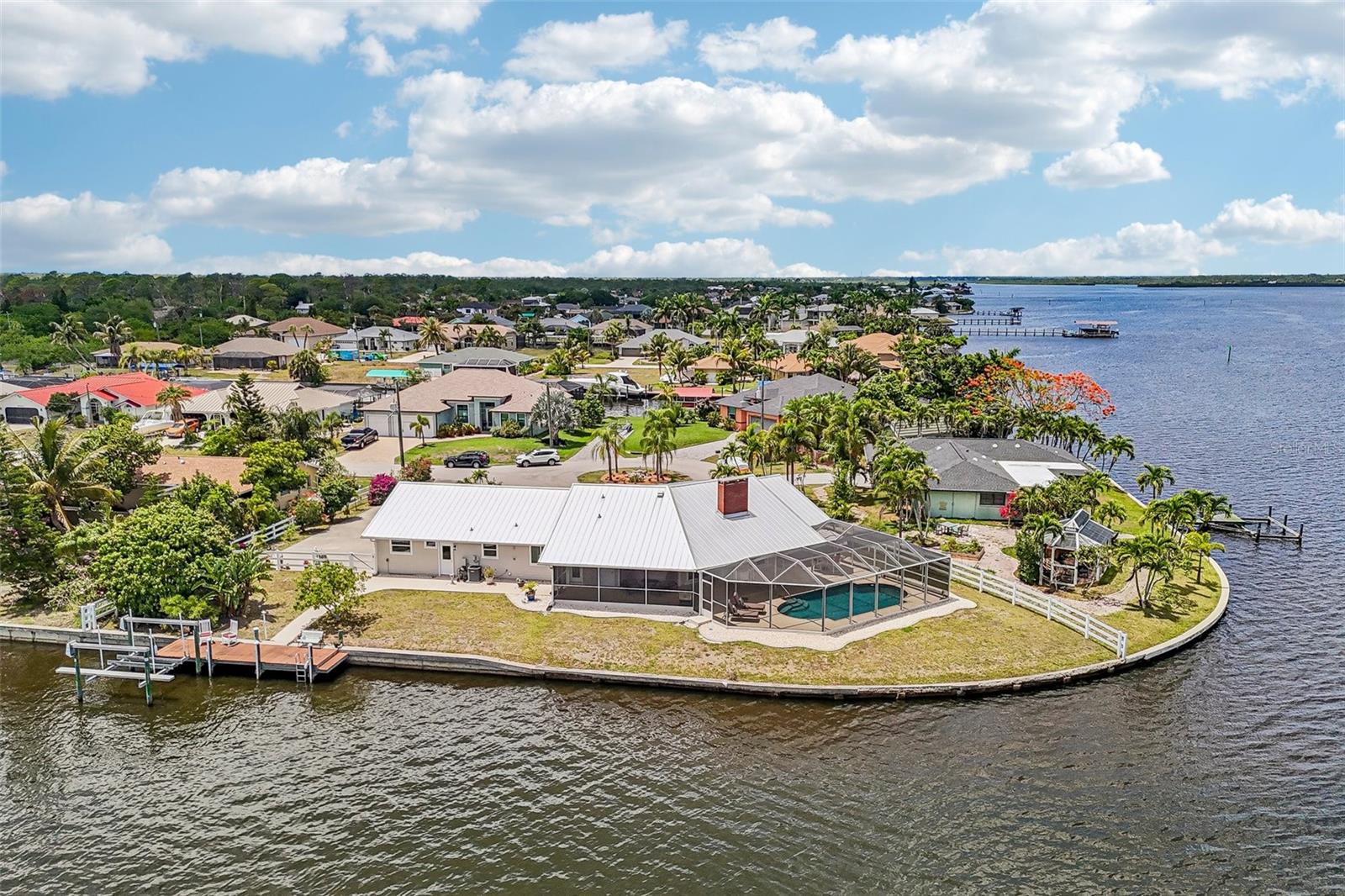 Experience a rare waterfront oasis at the end of a quiet cul-de-sac! This stunning 3BR, 2.5BA home spans 2,189 SQ FT, offering unmatched panoramic views of the canal and Myakka River from every living area. Boasting a massive 190’ seawall, the exterior is a certified fortress: new 24-gauge standing seam metal roof, James Hardie siding, new aluminum gutters/soffits, PGT Impact windows/doors, and 4 new motorized roll-down hurricane shutters. 
Step inside, to the open floor plan that displays a chef’s kitchen featuring new quartz counters, custom cabinets, a new GE Profile Smart Induction cooktop, new double wall oven, and new smart dishwasher with island and walk in pantry.  The master bath is equally updated with matching quartz and cabinetry. Rest easy with dual A/C systems for zoned climate control, dual water heaters for endless hot water, a newly serviced septic (4/24), and 2 room safes. 
The outdoor paradise shines with a freshly resurfaced pebble/glass tile pool, a Buttercream sand ship-seal deck, and a new pool cage with no-see-um screens, all framed by mature mango and avocado trees on oversized lot.  Private dock with boat lift is ready for your toys!
Truly a remarkable property!  Schedule your private showing today!
