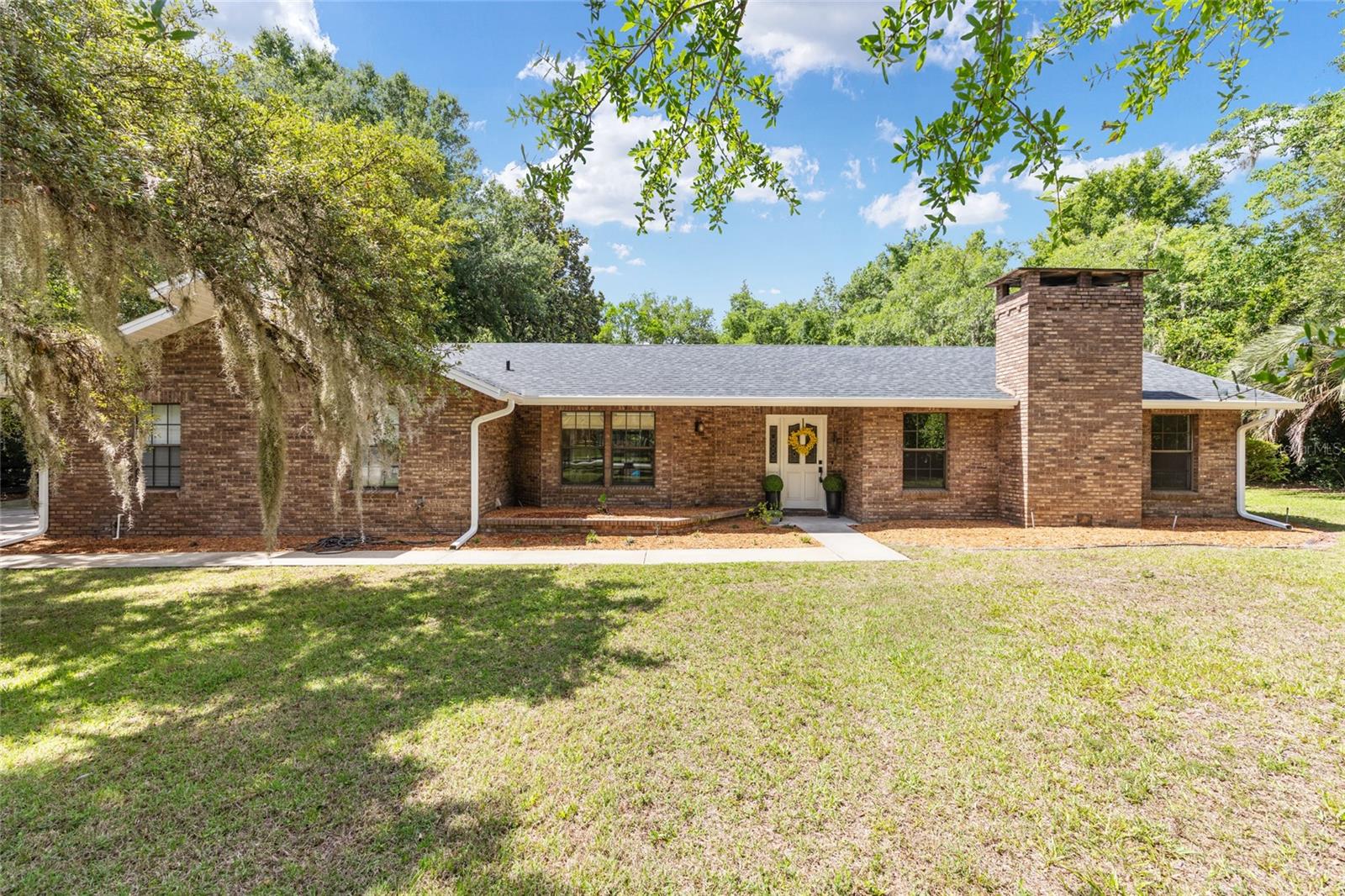 Private Ocala Retreat | Over 1 Acre | Pool Home | Detached Flex Building |

Discover the perfect blend of privacy, convenience, and Florida lifestyle living in this beautifully renewed estate, ideally situated in one of Ocala’s most desirable established communities. Surrounded by mature landscaping, spacious homesites, and signature black board fencing, this move-in-ready estate offers the tranquility of country living with the convenience of being just minutes from Ocala’s hospitals, shopping, dining, entertainment, and everyday amenities.

Nestled on over an acre of meticulously maintained grounds, the property welcomes you with a park-like setting featuring mature azaleas, majestic palms, magnolia trees, tropical landscaping, a peach tree, shaded walking paths, and lush greenery throughout the fully irrigated grounds.

The beautifully updated main residence features a thoughtfully designed split-bedroom floor plan with 3 bedrooms, 2 bathrooms, and an attached 2-car garage. The heart of the home is the expansive custom kitchen, designed with quality craftsmanship, upgraded finishes, abundant storage, and the perfect layout for gathering and entertaining.

The spacious primary suite includes laminate flooring & provides a relaxing retreat with a luxurious renovated bathroom, while the flexible Florida room creates additional living space with seamless indoor-outdoor connection through sliding doors from multiple rooms. Step outside to your oversized private pool area—perfect for entertaining guests, enjoying quiet mornings, or embracing Florida’s year-round outdoor lifestyle.

A rare highlight of this property is the impressive 1,040 sq. ft. air-conditioned detached building offering endless possibilities. Complete with an additional garage bay and side entry, this versatile space is ideal for a private gym, yoga studio, game room, workshop, hobby space, home business, creative studio, or additional storage.

With ample backyard space for RVs, boats, trailers, and outdoor recreation, this property delivers flexibility rarely found while maintaining a beautifully polished residential setting.

Thoughtfully renewed with quality workmanship and attention to detail throughout, this exceptional Ocala property offers the best of both worlds, a little bit country, a little bit town, and truly the Florida lifestyle you have been waiting for.

Conveniently located in the heart of Marion County with easy access to Ocala’s top destinations, outdoor recreation, equestrian venues, and an easy drive to Florida’s beautiful coasts.

Private. Updated. Spacious. Truly Ocala living at its finest. ROOF 2021, AC 2023, GUTTERS 2026