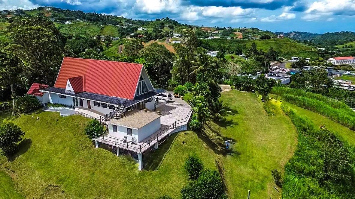 One or more photo(s) has been virtually staged. A Rare Hilltop Development Opportunity in Puerto Rico’s Mountains
7.37 Cuerdas | SU | R-1 | Panoramic Views | Mixed-Use Potential

Set high in the mountains of Barranquitas, this 7.37-cuerda (˜28,982 m²) property offers a unique opportunity for development, hospitality, or a private destination concept. Comprised of two parcels sold together, the site is classified as SU (Urban Soil) and zoned R-1, with water and electricity available.

At the highest point of the property sits an existing two-level structure, positioned to capture panoramic views of Puerto Rico’s central mountain range. The main level features approximately 1,780 sq ft, with additional second-level space, offering a flexible foundation for a restaurant, viewpoint, or hospitality concept. The structure includes four restrooms (two women’s, two men’s), supporting future commercial or guest use.

The surrounding land creates further opportunity for expansion, including potential retreat villas, micro-homes, or boutique lodging concepts (subject to permitting). Nine individual lots have already been segregated, along with a larger parcel where the hilltop structure is located, allowing for multiple development strategies.

This property is ideal for developers, hospitality groups, or investors seeking to create a destination-driven project in one of Puerto Rico’s most scenic mountain regions.

Disclaimer: Some images may be virtually staged or enhanced for illustrative purposes only.