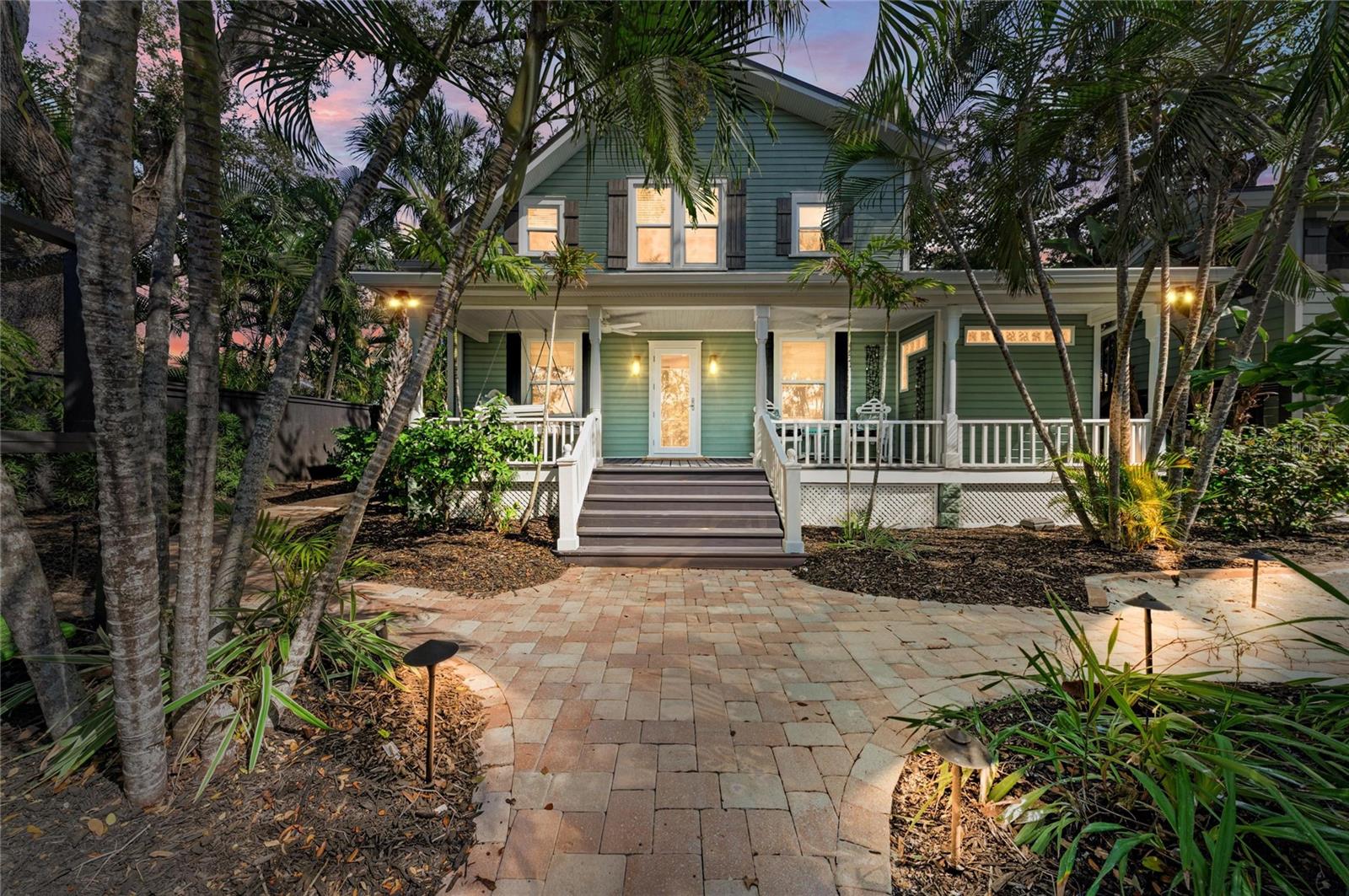 Located in Sarasota’s established West of Trail neighborhood, this gated and fenced 1920 Craftsman residence offers a rare double lot and a guest cottage. Originally constructed in 1920 and comprehensively renovated in 2025 and 2026, the property preserves its architectural character while integrating modern systems, finishes and upgrades including all impact windows and doors. Spanning 3,609 total square feet, the estate is designed for privacy and flexibility. The main residence includes three bedrooms and two and one-half baths. The primary suite is positioned on the main level with direct access to the pool and courtyard, along with a spacious walk-in closet. Large-format porcelain block flooring extends throughout, complemented by updated lighting and professionally curated design elements introduced during the full vintage renovation. The kitchen supports both daily living and entertaining, anchored by a substantial island with quartz countertops, new appliances and a natural gas five-burner range. A dining nook overlooks the pool and courtyard, while adjacent living and lounge areas create seamless gathering spaces. Outdoor living centers around a private courtyard featuring a heated saltwater pool and spa with rock fountain feature, outdoor kitchen, multiple balconies and sitting areas, a sweeping front porch and the landscape lighting is strategically set among the mature Florida landscaping. A custom-built treehouse fort and chicken coop contribute additional character to the grounds. A detached, air-conditioned two-car garage includes a self-contained guest cottage above with one bedroom, office and one bath, with additional covered parking offering flexibility for extended family, guests or potential rental income. Conveniently located near Hillview Street dining and shopping, Morton’s market, the bayfront, Downtown Sarasota and Southside Elementary School, this property combines preserved Craftsman architecture with modern livability in one of Sarasota’s most desirable in-town locations. Can be sold furnished.