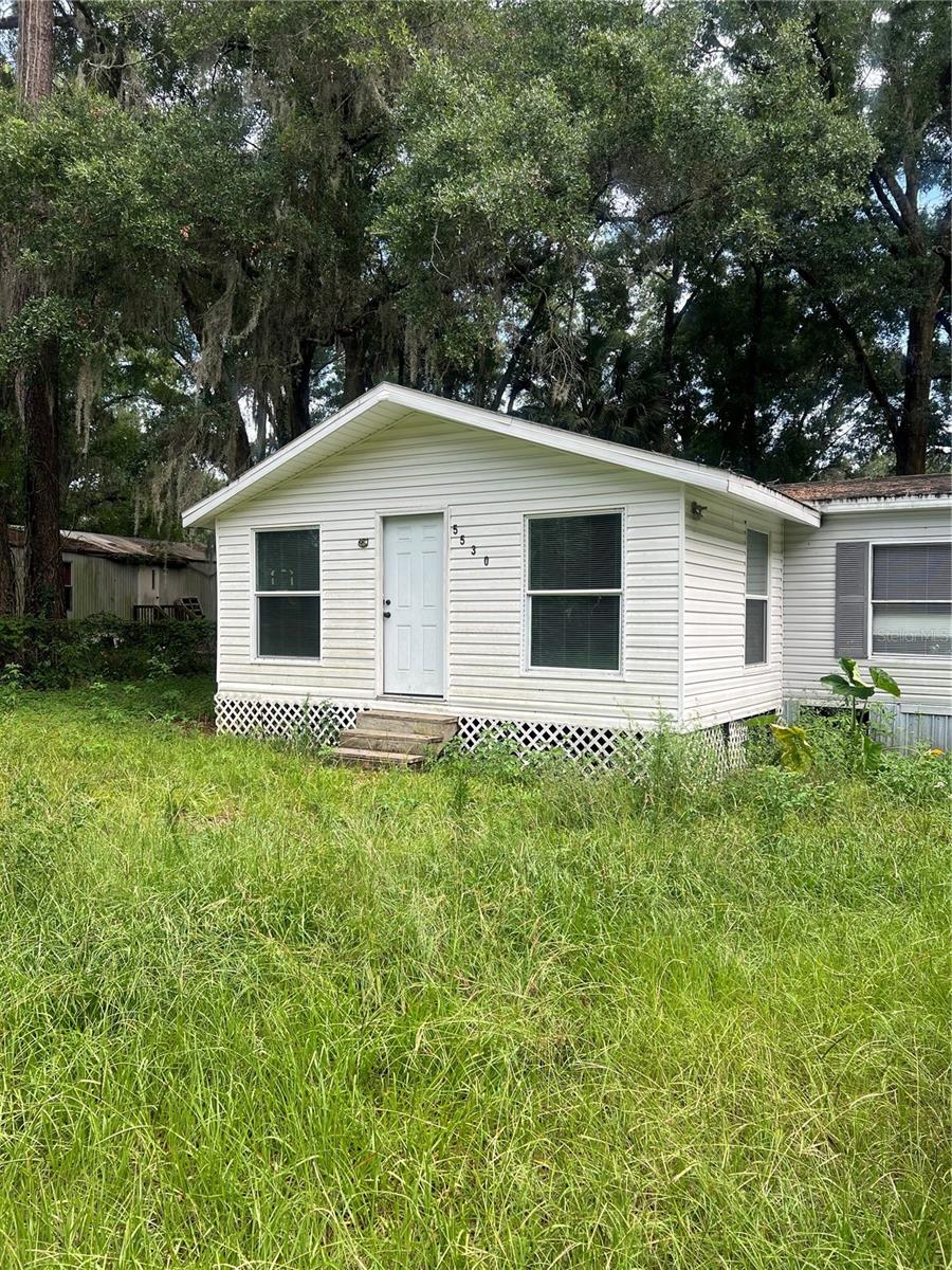 Investor opportunity / handyman special. 3 bedroom, 2 bathroom manufactured home with additions. Property offers solid structure and strong potential with updates and improvements needed throughout. Home is being sold AS-IS. Exterior landscaping will need attention. Paved road access with some areas of deterioration/potholes and a short unpaved/dirt drive leads to the property. Carport is unfinished. Property presents a great opportunity for renovation, rental, or value-add investment. Buyer to verify all information including condition, utilities, and land use.