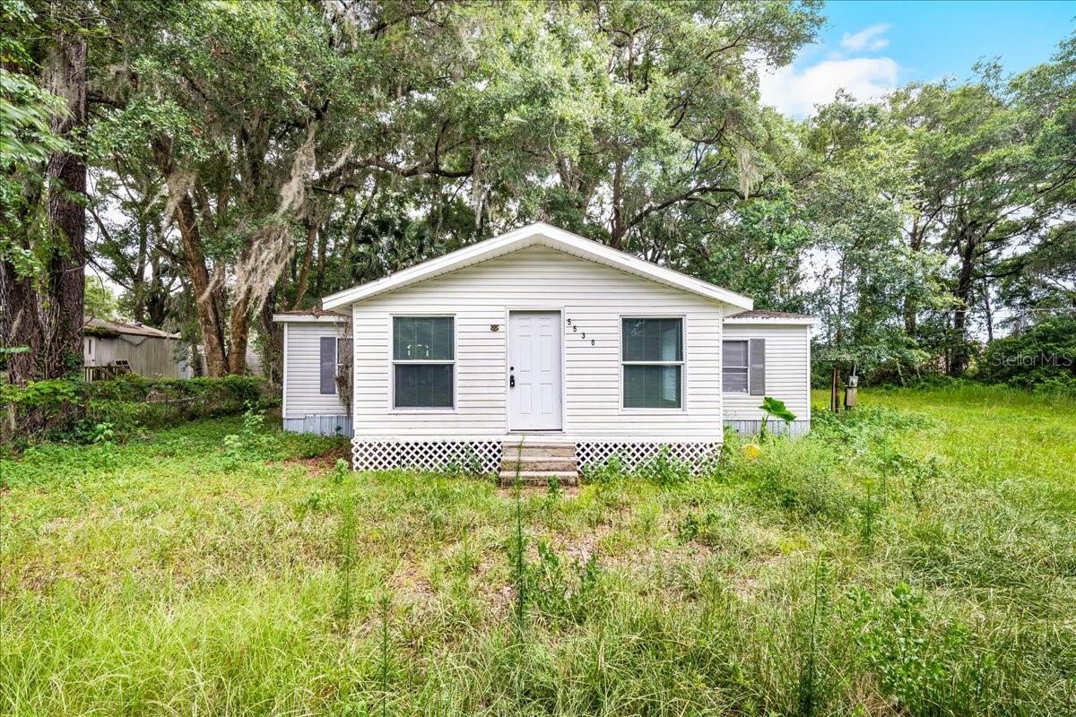 Investor opportunity / handyman special. 3 bedroom, 2 bathroom manufactured home with additions. Property offers solid structure and strong potential with updates and improvements needed throughout. Home is being sold AS-IS. Exterior landscaping will need attention. Paved road access with some areas of deterioration/potholes and a short unpaved/dirt drive leads to the property. Carport is unfinished. Property presents a great opportunity for renovation, rental, or value-add investment. Buyer to verify all information including condition, utilities, and land use.