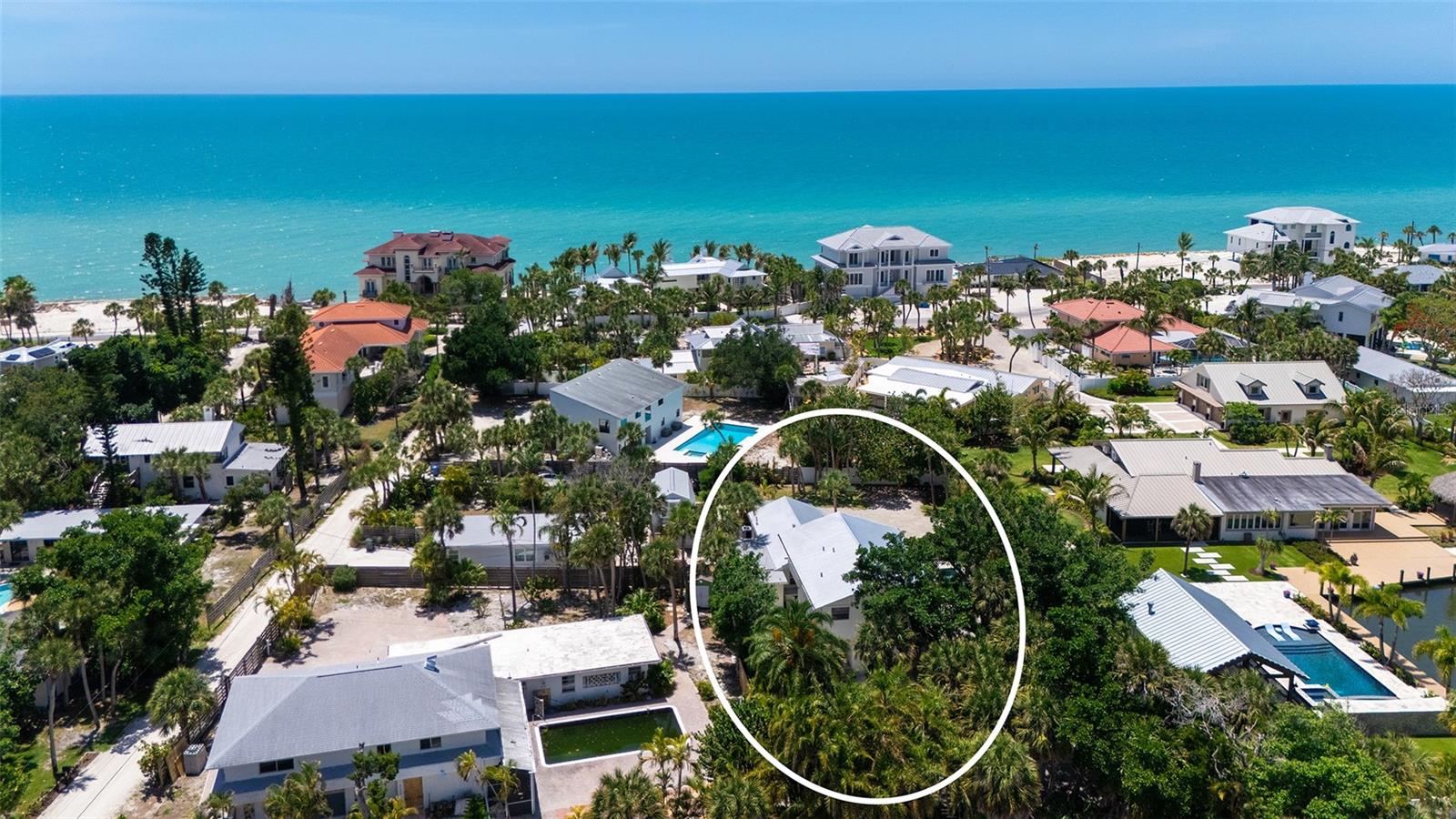 Welcome to your private coastal retreat on the barrier island of Casey Key. Nestled along charming Sandspur Lane, this exceptional home is ideally positioned between the Gulf of Mexico and Little Sarasota Bay, just three homes from private deeded beach access. Offering the perfect blend of island charm and resort-style living, this property captures the essence of Florida’s coveted salt life lifestyle. The beautifully remodeled kitchen flows seamlessly into the spacious family and dining areas, creating an inviting space for entertaining and everyday living. The main residence features two generously sized bedrooms along with two versatile bonus rooms ideal for a home office, fitness studio, game room or additional guest accommodations. An attached one-bedroom in-law guest suite provides privacy and flexibility for extended family or visiting guests, making this home perfectly suited for multigenerational living or hosting. Outside, the lush tropical backyard feels like a private botanical oasis centered around a stunning 2017-built swimming pool, expansive decks and multiple outdoor living and dining spaces designed for relaxation and entertaining. Moments away, the community dock offers easy access to Little Sarasota Bay for kayaking and paddleboarding, and the beach access is perfect for enjoying breathtaking sunsets. Within Casey Key’s protected conservation district, this rare island community preserves its timeless character with no high-rise development and exclusively single-family homes. Conveniently located near downtown Venice and just a short drive to Sarasota, you’ll enjoy easy access to dining, shopping, marinas and local waterfront favorites. Experience the best of coastal living in one of Southwest Florida’s treasured island communities.