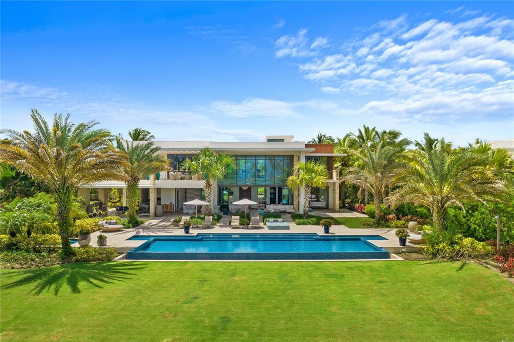 On Dorado’s most coveted street, overlooking the ocean and the rolling fairways of the golf course within the Ritz-Carlton Reserve sits an amazingly spectacular world class property.  This ultra-luxurious home boasts 12,949 sq. ft. of utmost elegance in a 1-acre ocean front lot, with 5 bedrooms plus an independent guest bedroom suite.  Distinguished by a unique modern design that beautifully combines nature and artistry, this is truly one of Dorado Beach’s most exclusive residences.
            Everything shows exquisite attention to detail in this incredibly spacious home where high ceilings and natural light abound, from its impressive foyer to the grand living room with dramatic 24 feet high floor to ceiling glass doors opening to the expansive outdoor grounds boasting an extraordinary terrace with outdoor kitchen and a pool with jacuzzi overlooking the golf course and ocean. On the main floor, the home features 2 bedroom suites, both with outdoor showers leading to the beautifully landscaped and lush green areas. The home also features a gourmet chef’s kitchen with high-end appliances (Wolf, Sub-Zero, Miele) and Poliform cabinets. The villa’s modern floor-plan is ideal for entertaining since all the common areas open to the fabulous outdoor space via sliding glass pocket doors.
A dramatic glass wall staircase welcomes you to the 2nd floor floating over a beautiful water feature. Upstairs you will find 2 bedroom suites, a 2nd dedicated laundry room, an open office space with sitting area leading to the magnificent master bedroom suite that encompasses the entire 2nd floor right wing.  The luxurious master suite has a private terrace where you can watch daily sunsets while listening to the sound of the waves plus an impressive his and hers walking closets and bathroom suite with outdoor shower.
On the main floor, home also features a mud room with half bath, an ample laundry room, a 4 car garage and 2 visitors parking spaces. 
            
East Beach Villa #7 is being sold as is and turn-key. Property was decorated in 2017 by a well-known and local interior designer.   Showings by appointment only with minimum 48 hour advance notice.  Proof of funds is required.