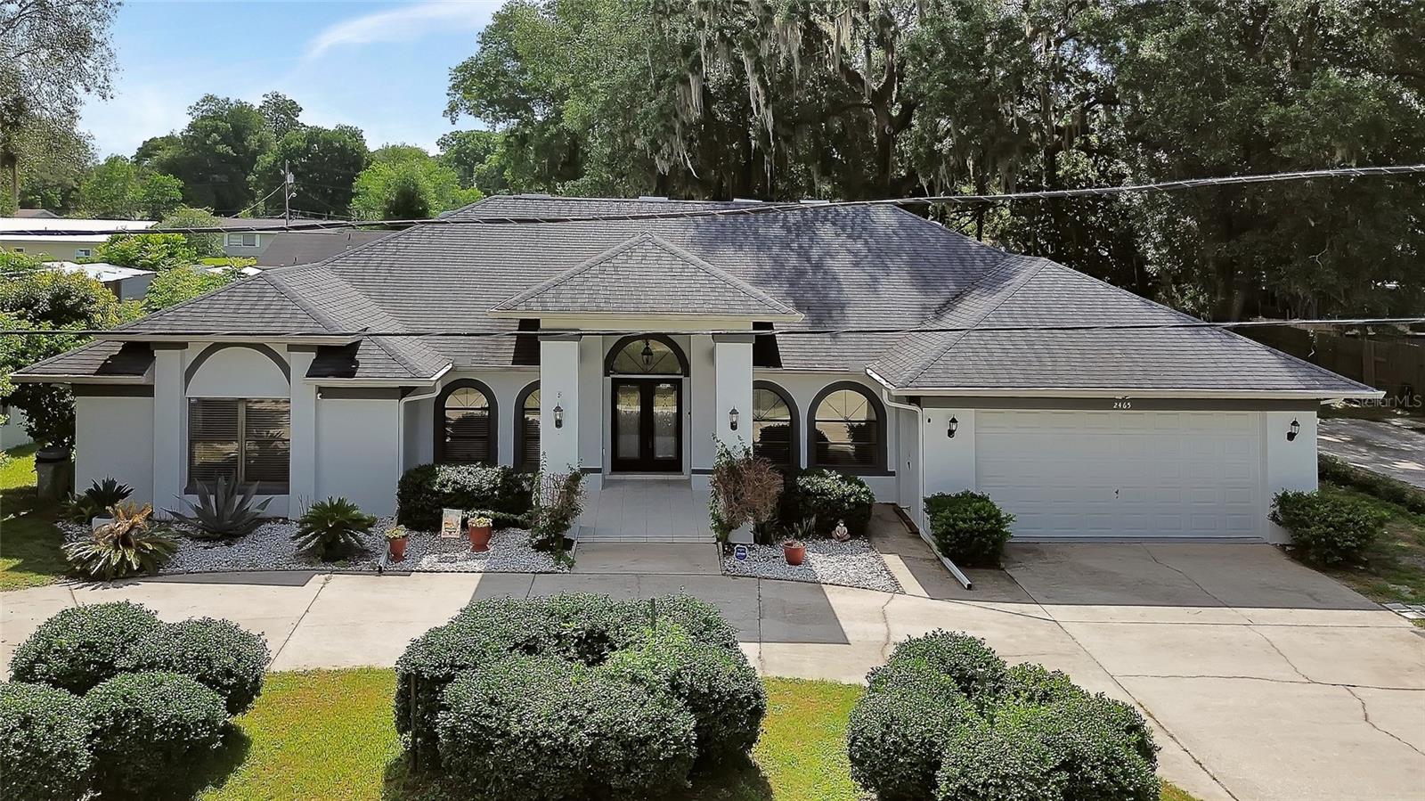 Virtually Staged. Looking for SPACE, SOLID CONSTRUCTION, and a great LOCATION? This well-built 4-bedroom, 2.5-bath home is located in an established DeLand community with no HOA and offers the opportunity to add your personal touches while enjoying numerous updates already completed. Situated on a spacious homesite with public water, SEPTIC, and a separate WELL for IRRIGATION, this property provides flexibility and functionality rarely found in today's newer developments.
The split-bedroom floor plan offers privacy for the PRIMARY suite, while all bedrooms are generously sized. The large LIVING ROOM boasts vaulted ceilings, 2 sky lights, vinyl plank flooring, fireplace, coat closet and serves as the heart of the home. French Doors lead to the 31 ft wide LANAI. Updated Kitchen offers 2 skylights, 2 wall ovens, breakfast bar, cooktop, pantry, microwave, 3 door refrigerator,and large dinette space  A versatile BONUS room can easily function as a home office, formal dining room, or formal living area to suit your needs. Enjoy Florida living year-round from the expansive COVERED and SCREENED lanai overlooking the fenced backyard. 
Outside, you'll find a unique combination block and wood privacy fence, a large storage shed, a 2-car garage, and a circular driveway providing ample parking for family and guests.
Conveniently located in DeLand, known for its charming downtown, local restaurants, shopping, and community events, this home offers easy access to Orlando, International Airports, area hospitals, and major roadways. East Coast beaches, including Daytona Beach and New Smyrna Beach, are just a short drive away, making it easy to enjoy the best of Central Florida. DeLand also serves as the northern terminus of the SunRail commuter rail system, providing convenient access throughout the Orlando area.
A wonderful opportunity for buyers seeking a spacious home in a well-established neighborhood with room to make it their own.