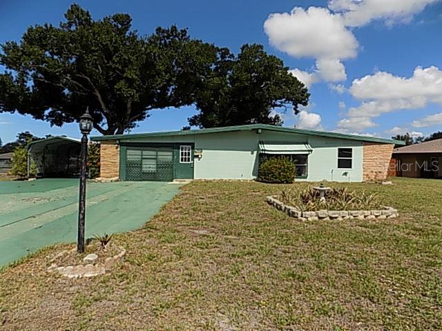 Adorable block home loaded with character offering 1,528 sq. ft., 3 bedrooms, 2 full bathrooms, vaulted ceilings, a 1-car garage, plus a 1-car carport with a circular driveway providing plenty of parking. Situated on an oversized .36-acre corner lot, the property is shaded by huge mature oak trees, creating a peaceful backyard setting. With a little vision and TLC, you can bring the sparkle back to this hidden gem. Located in Bayshore Gardens, residents enjoy an incredible array of amenities including a Jr. Olympic-size swimming pool, marina with private boat ramp and fishing pier, recreation hall, playground, picnic pavilions with BBQ grills, ball field, basketball and pickleball courts, plus numerous social clubs and activities, all just minutes from Sarasota Bay. HOA fee is paid through property taxes.