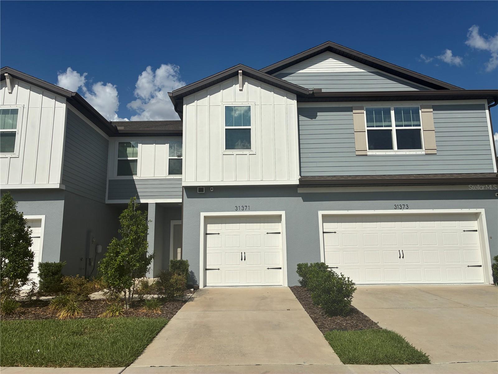 WESLEY CHAPEL TOWNHOME LIVING with space, convenience, and a flexible setup! This 3-bedroom, 2.5-bath townhome offers a functional layout with all bedrooms located upstairs along with the laundry area, keeping everyday living simple and organized. Downstairs features an open-concept floor plan that connects the living, dining, and kitchen spaces, plus a convenient half bath for guests. Step outside to enjoy the back patio—perfect for relaxing, enjoying your morning coffee, or winding down after the day. Offered partially furnished, this home gives you an easy move-in option while still leaving room to make the space your own. Conveniently located in Wesley Chapel close to shopping, dining, entertainment, and daily necessities. **Furniture that stays: Second bedroom furniture. Office room (bookshelf, desk and metal rack in the closet), living area (TV stand, Tv mount etc), living area (bookshelves wall mounted), Entry way (console table), Garage (metal storage shelf).**